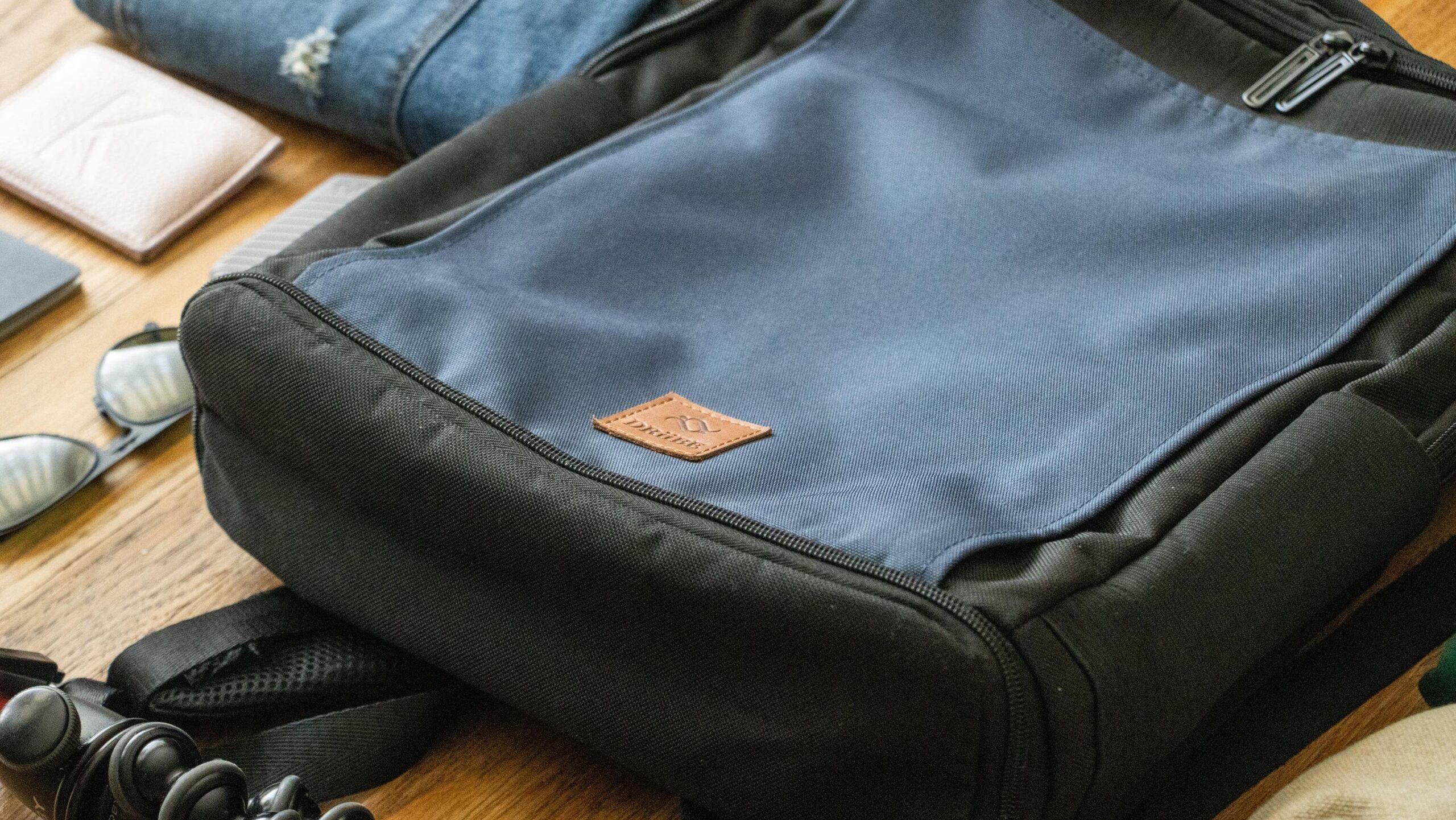 Black and blue backpack laid on floor.