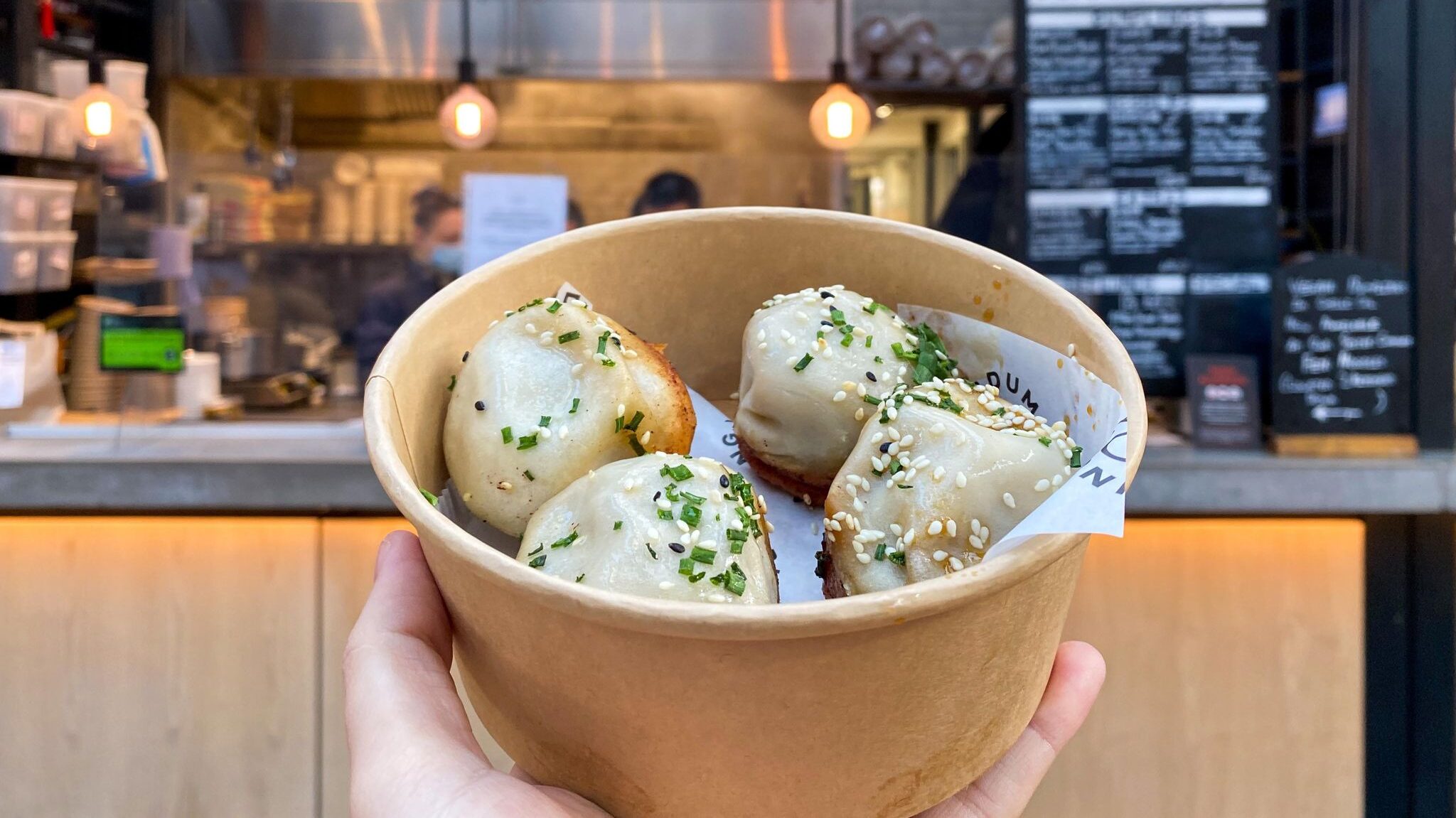 Cardboard bowl of fresh dumplings. 