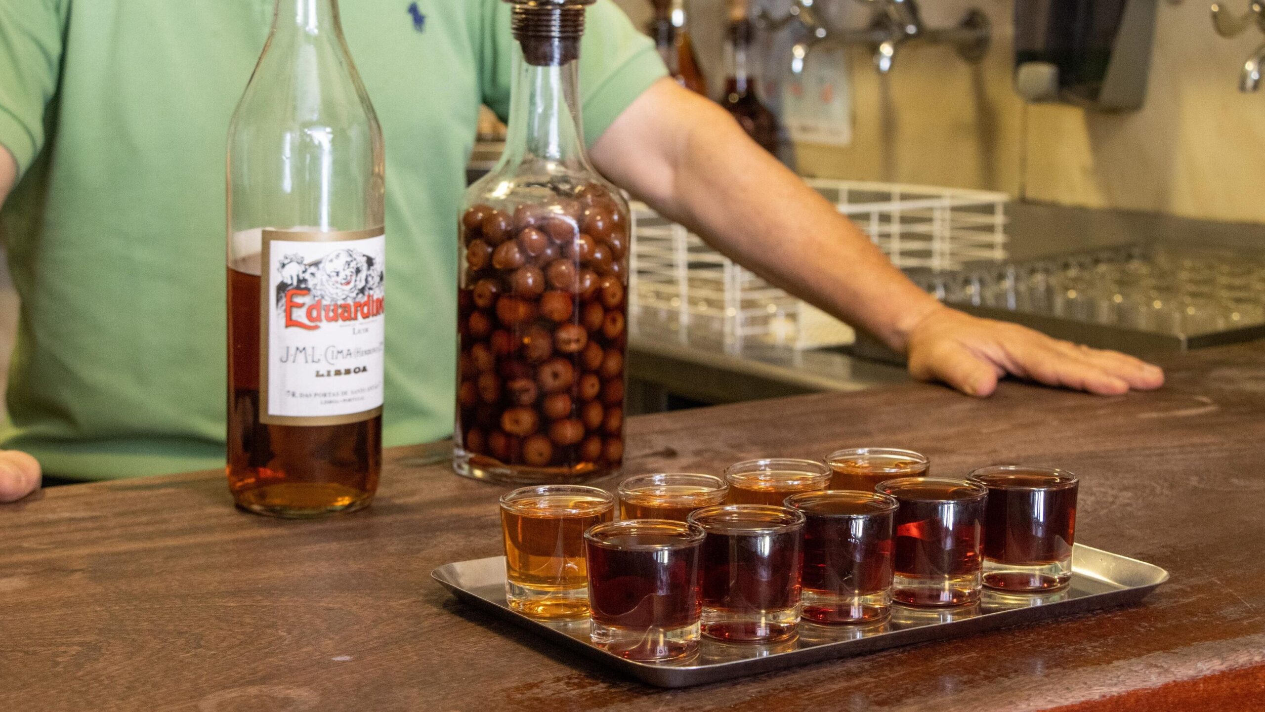 Rows of shot glasses with Portuguese spirit. 