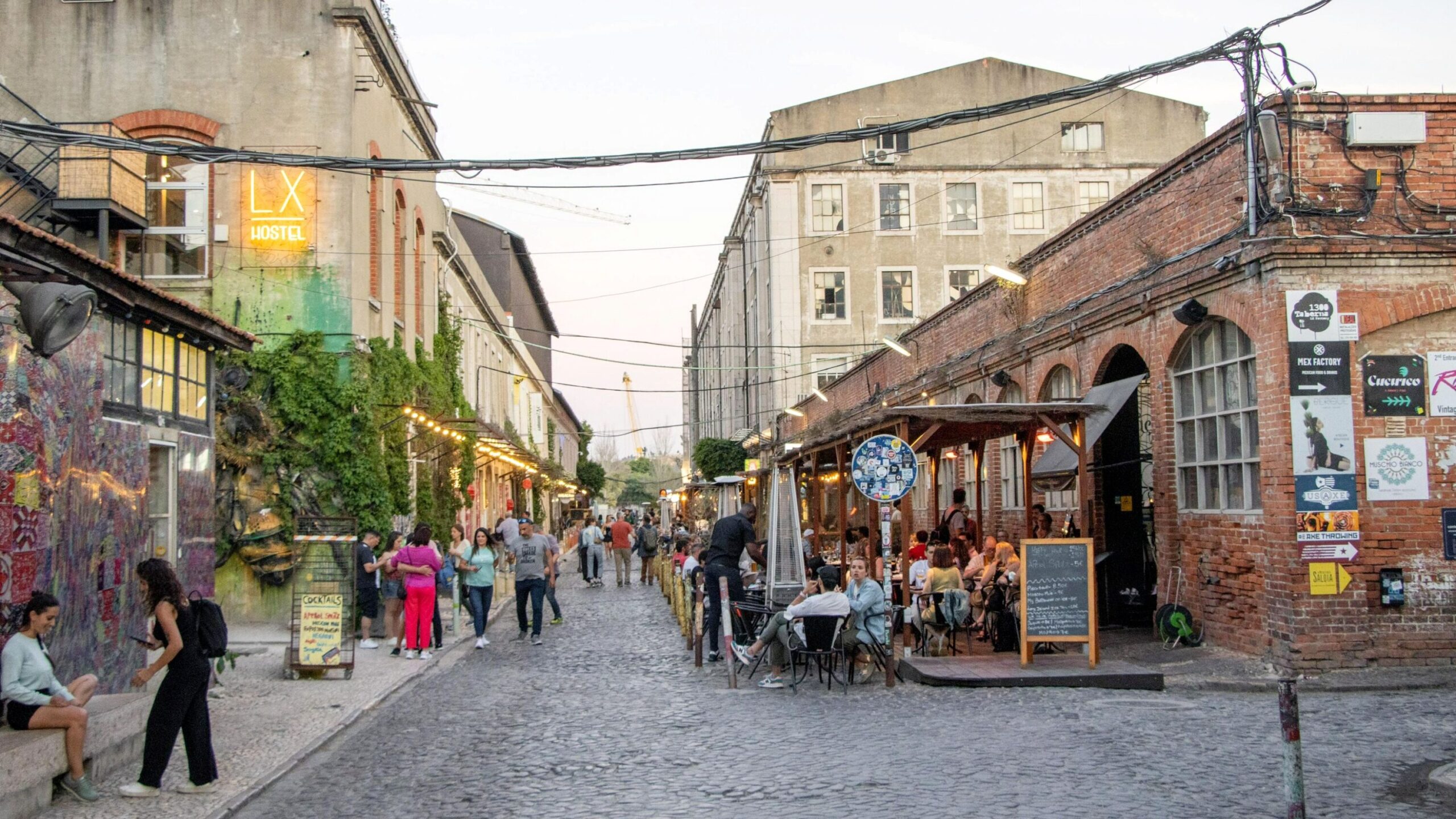 Street between warehouse buildings turned into restaurants.