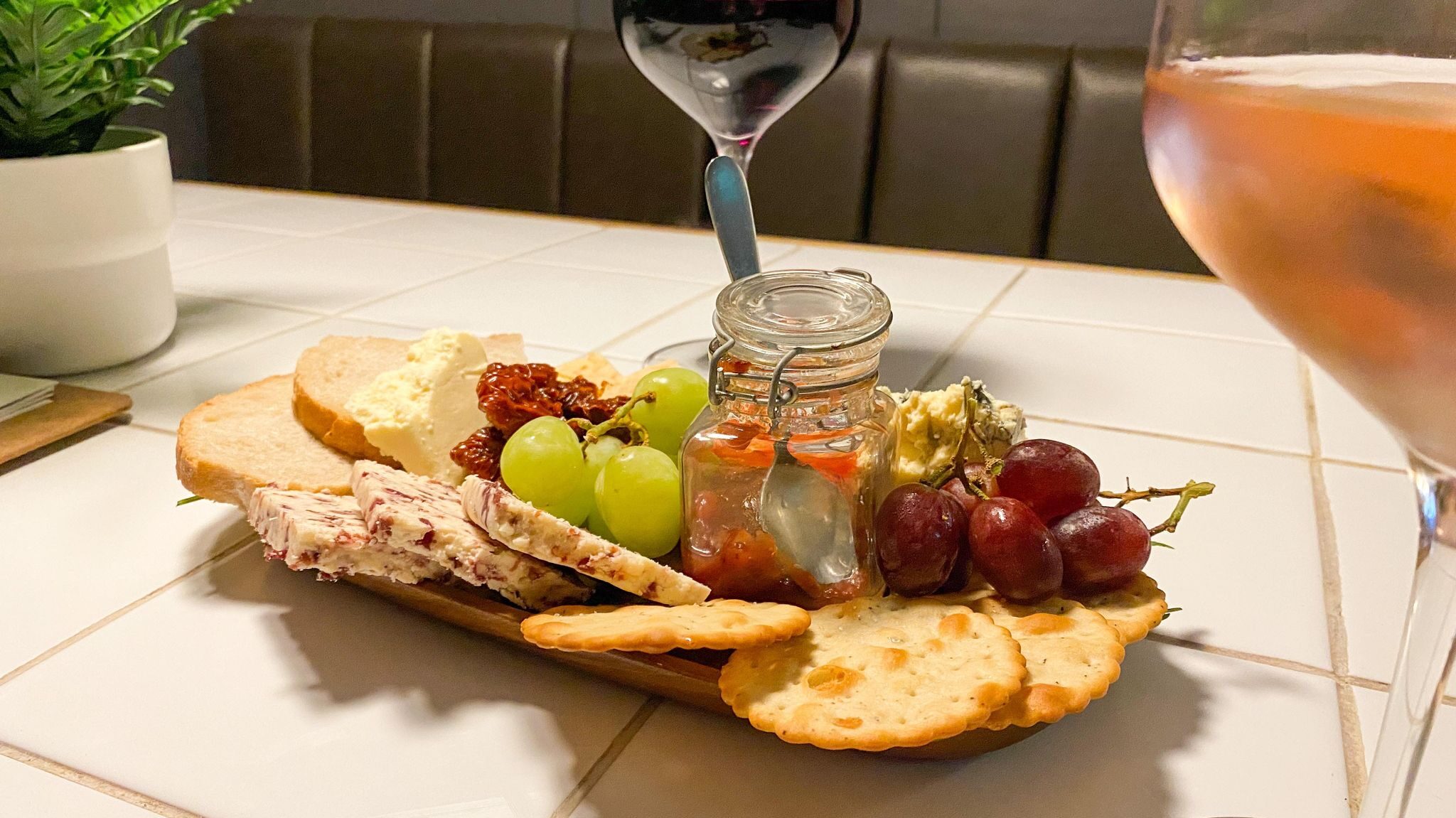 Platter of cheese and crackers with wine.