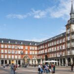 Large plaza in Madrid with people walking around.