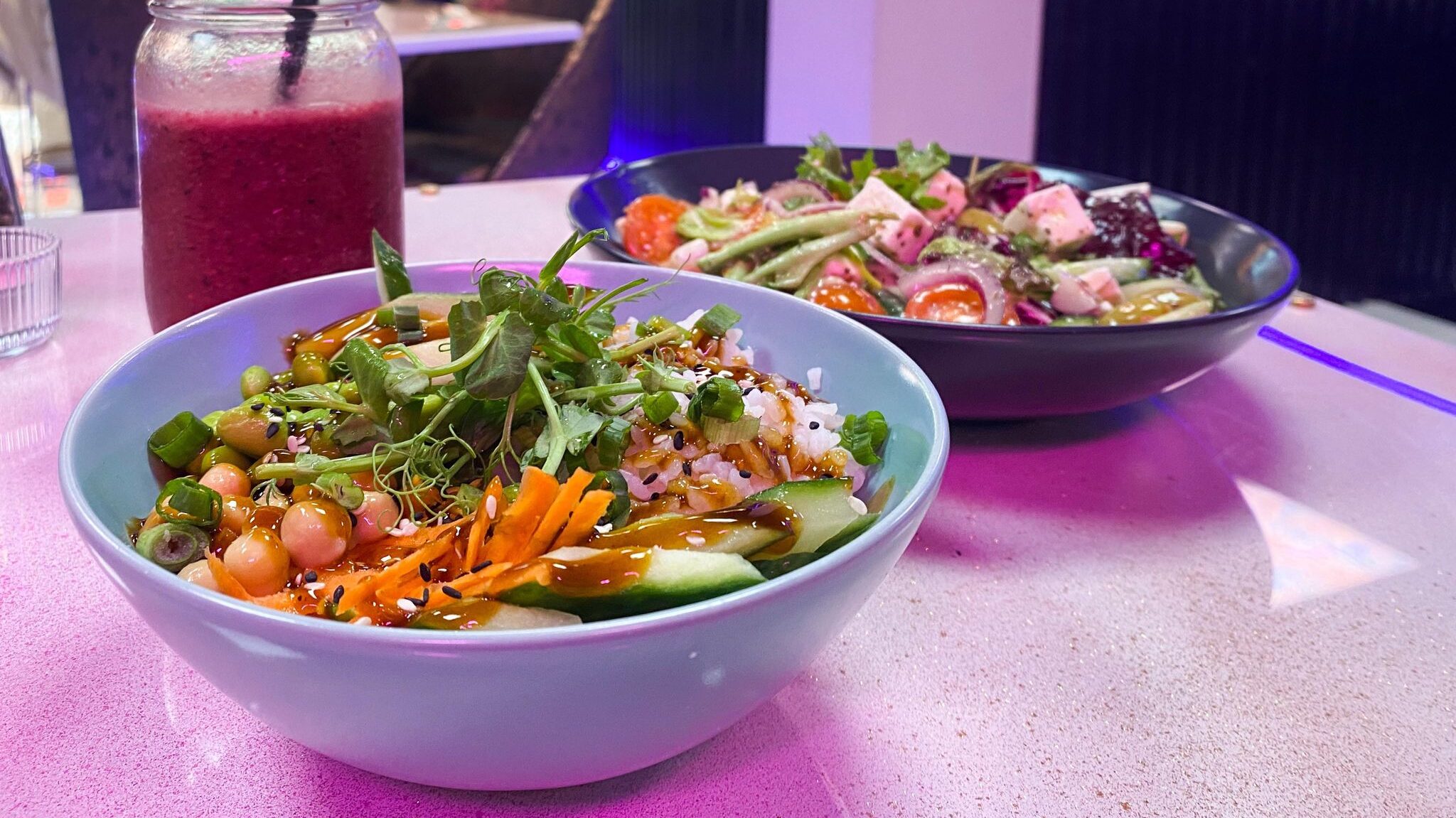 Bowls of healthy salads and fruit smoothie.