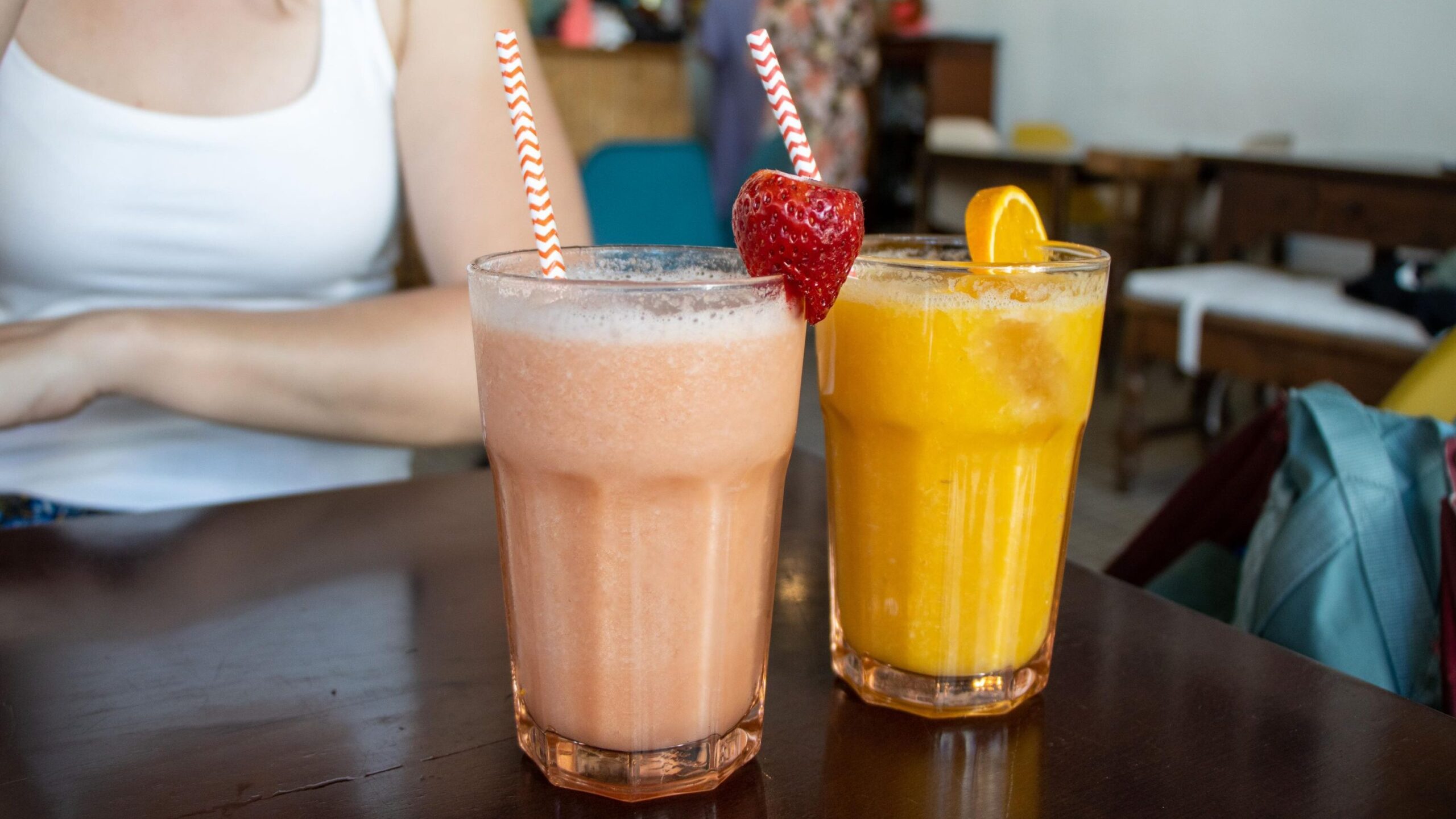 Two fresh fruit smoothies on table.