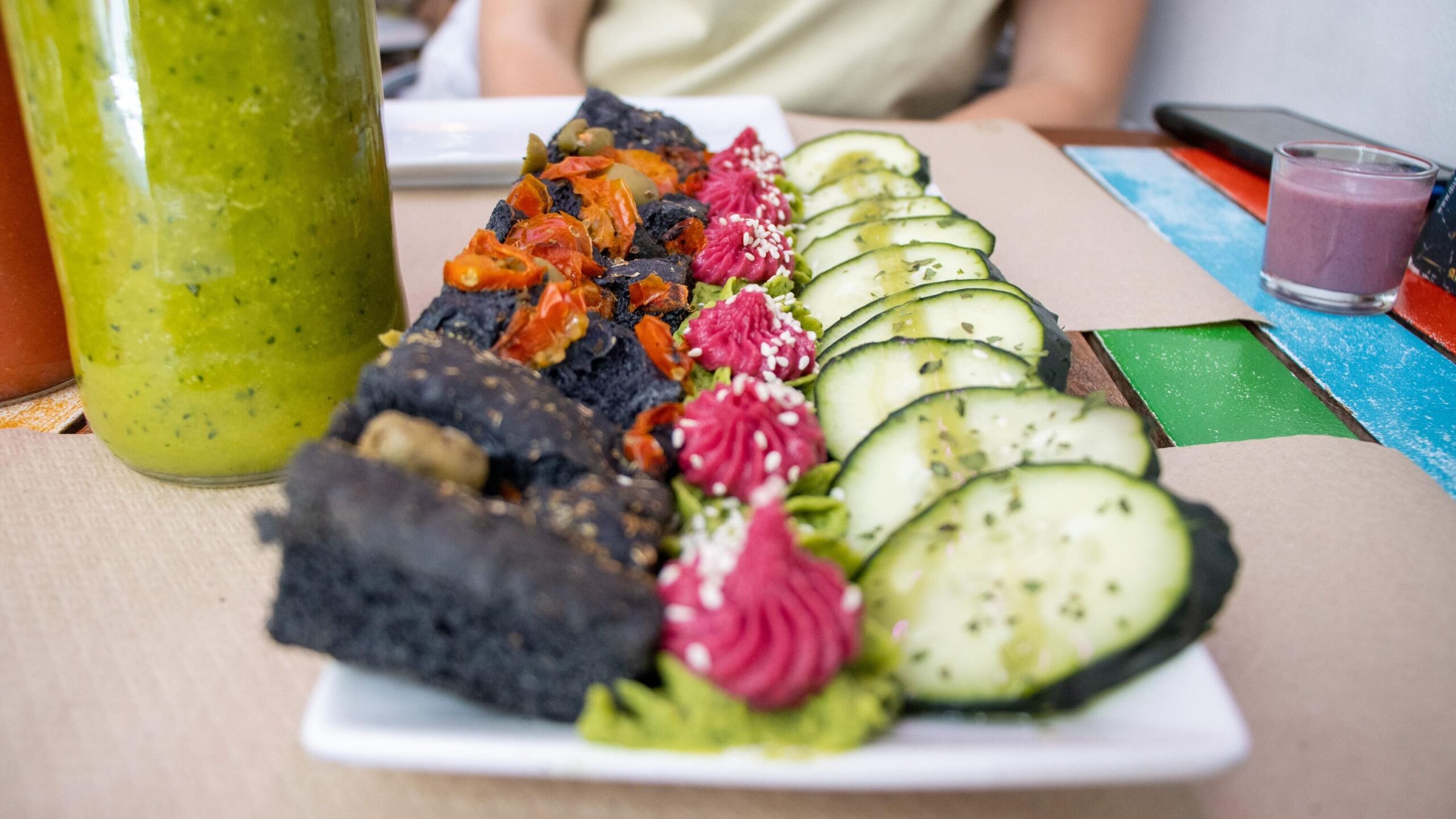 Plate of fresh vegetables with green juice.