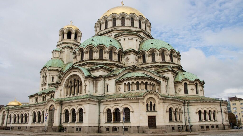 Large cathedral in the centre of road.