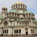 Large cathedral in the centre of road.