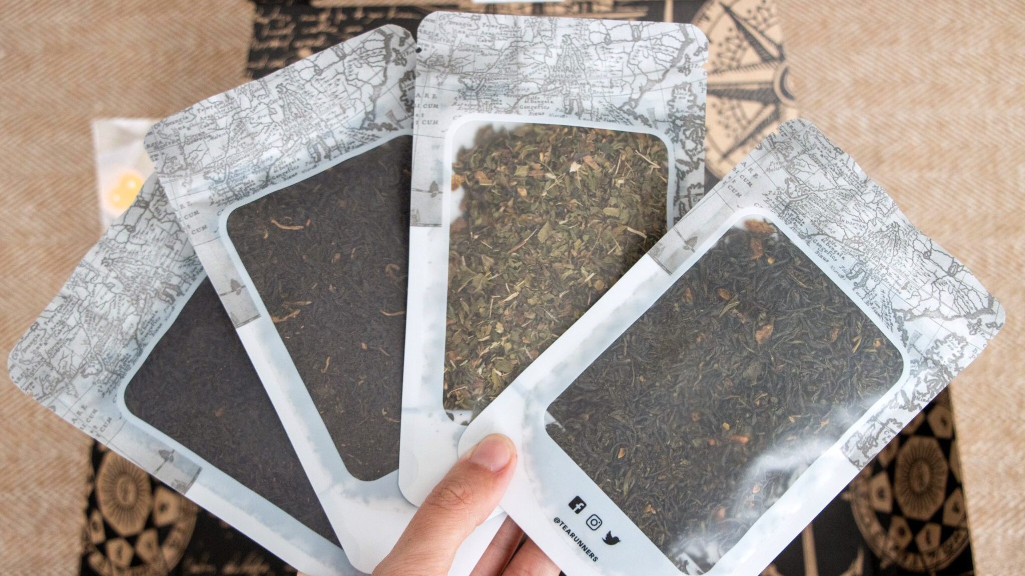 Four packages of loose tea leaves.