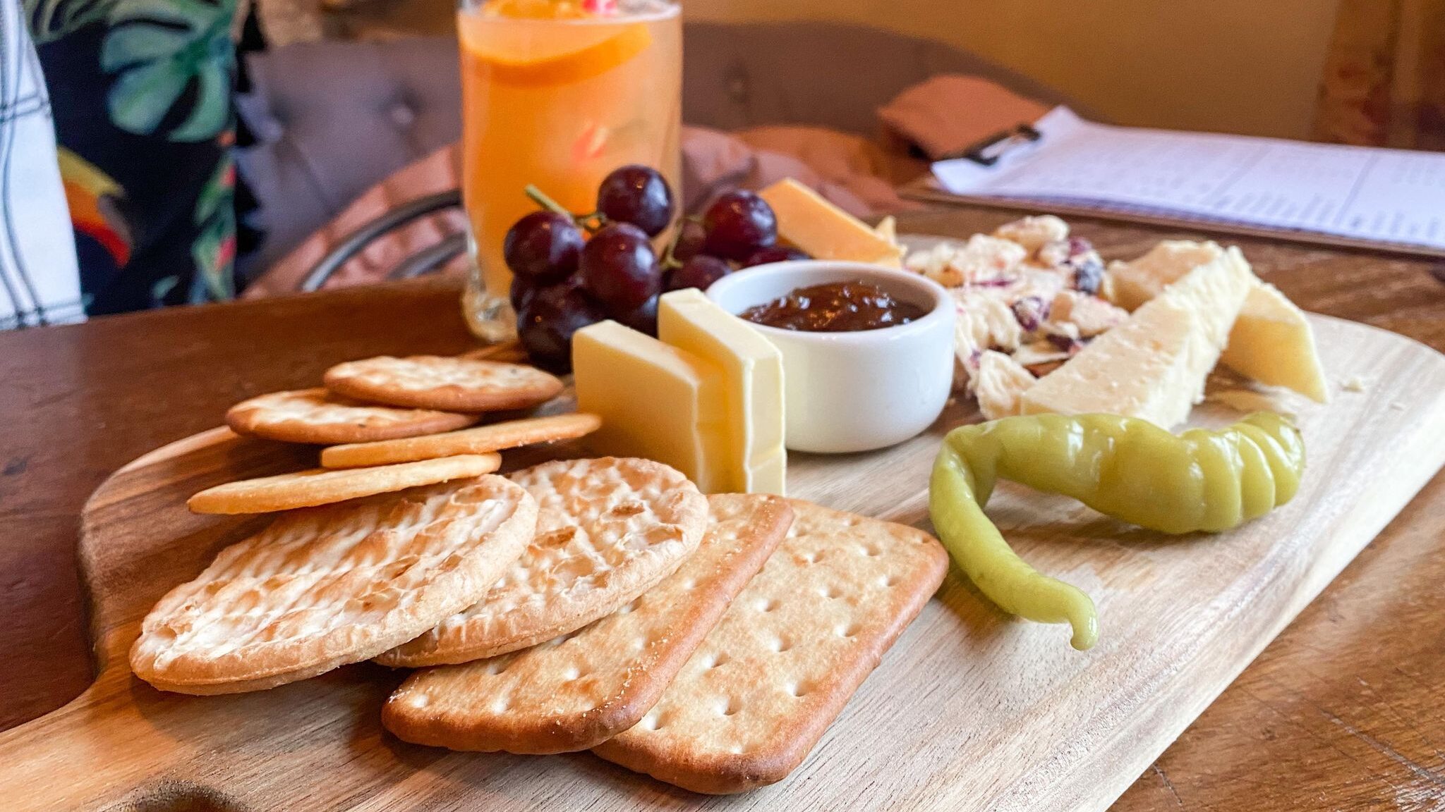 Cheese and cracker board with cocktails. 