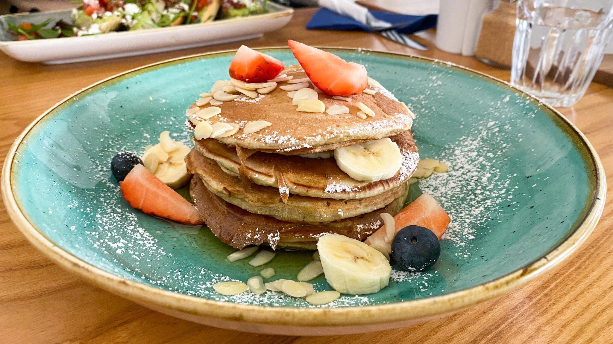 Blue plate with stacks of pancakes.