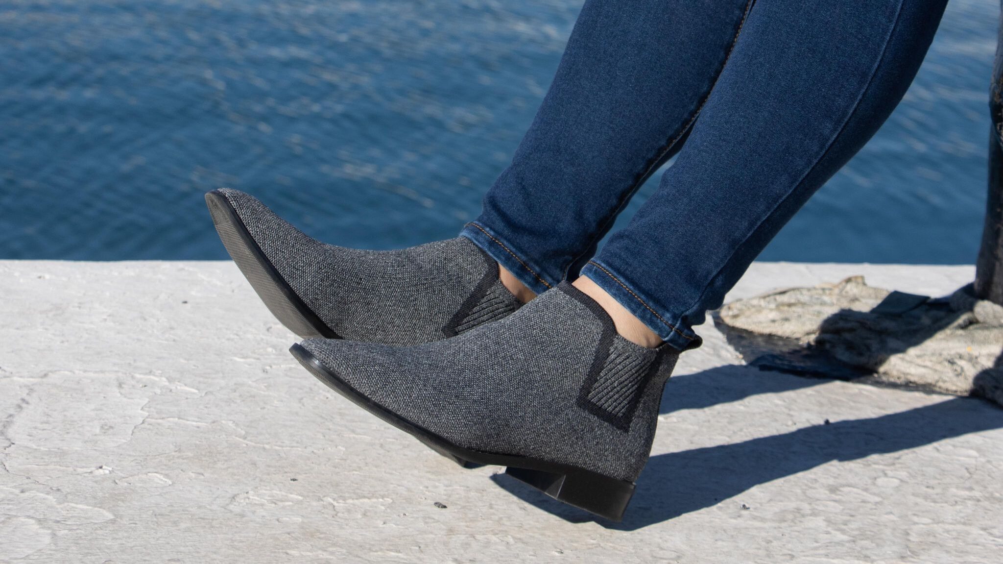 Grey ankle boots with black trim.