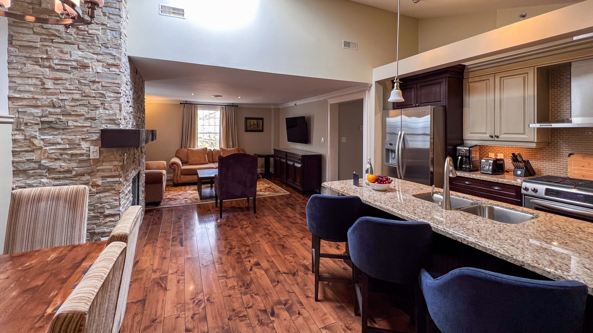 Open plan kitchen and living room in hotel suite.