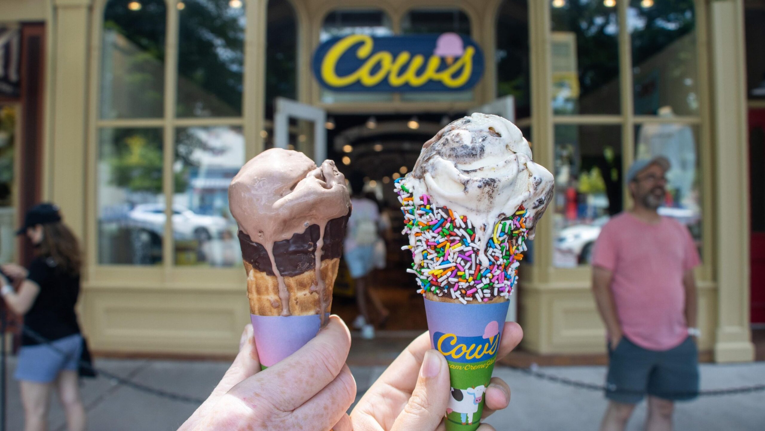 Two melting ice creams in front of store.