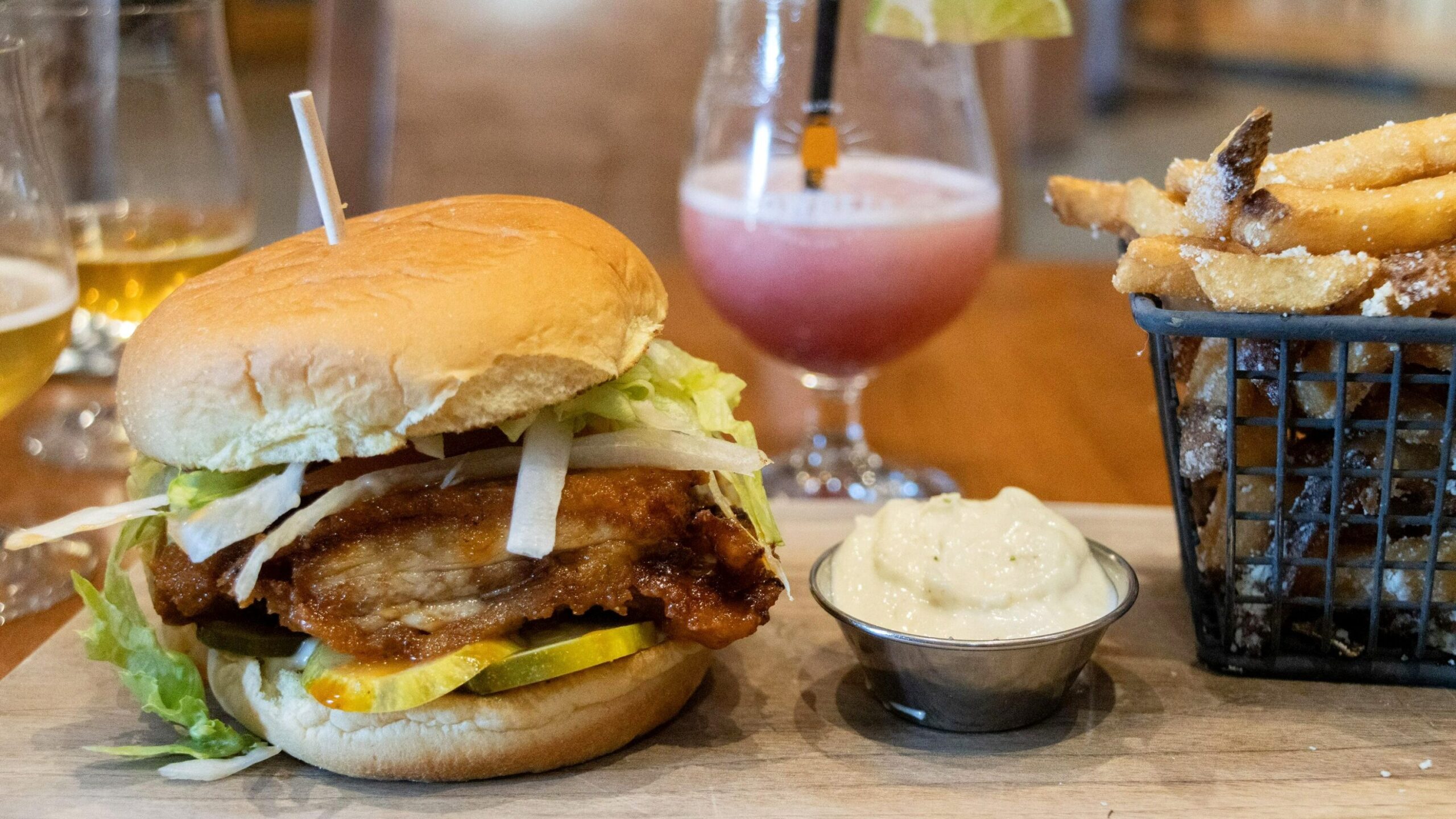 Chicken burger and cocktail in brewery. 