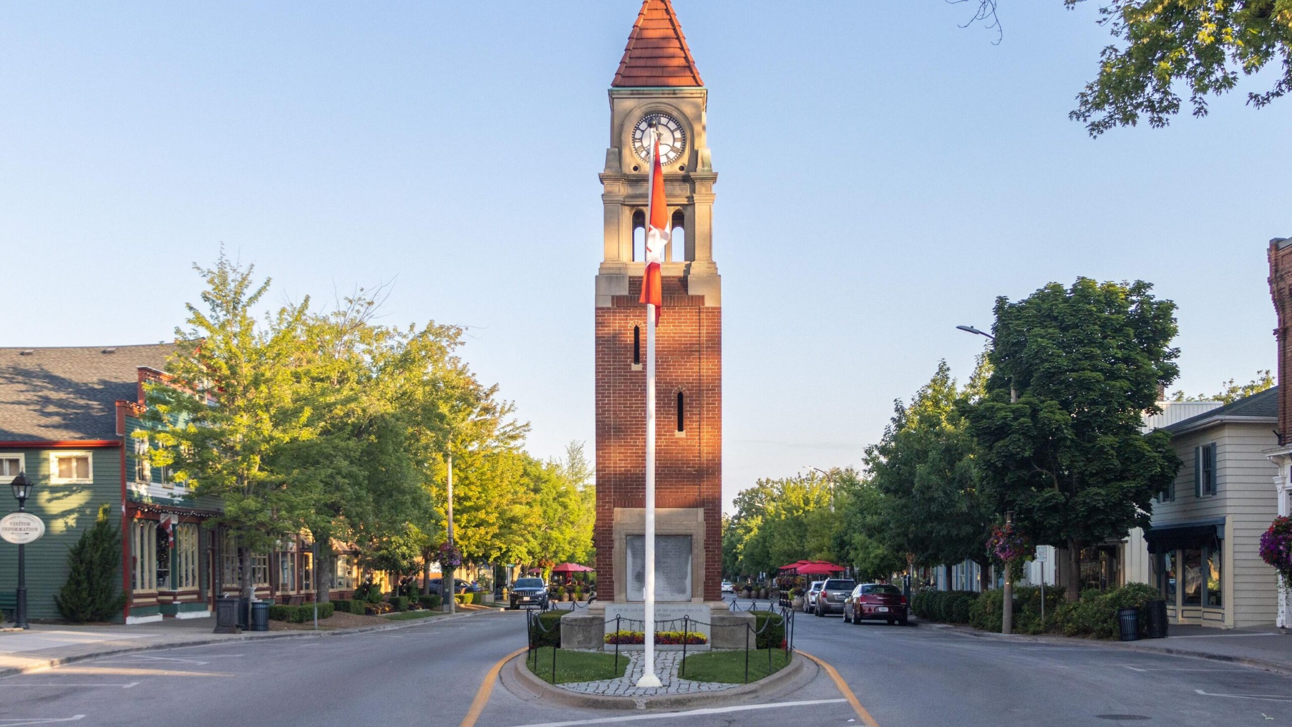 Tall memorial clock tower in the middle of the street.