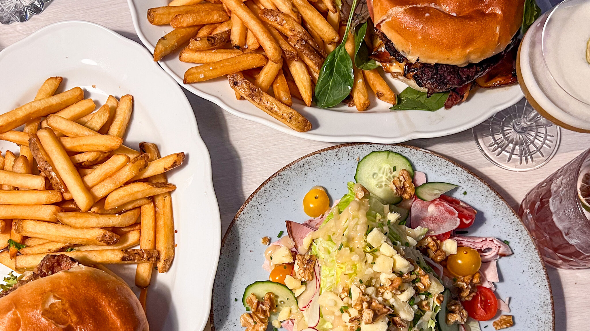 Burgers and salad on table in restaurant.