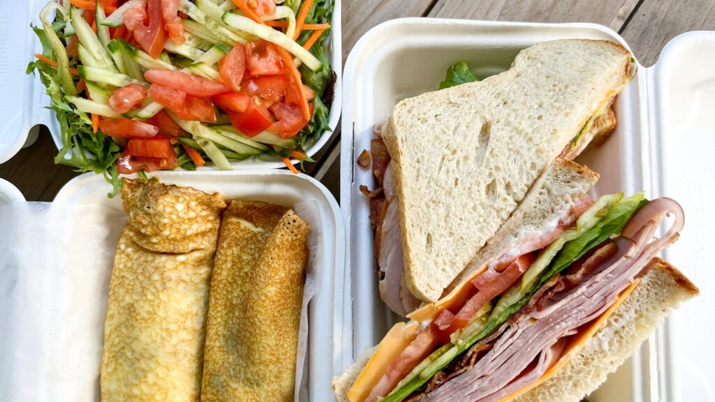 Large ham sandwich and savoury crepe with salad.