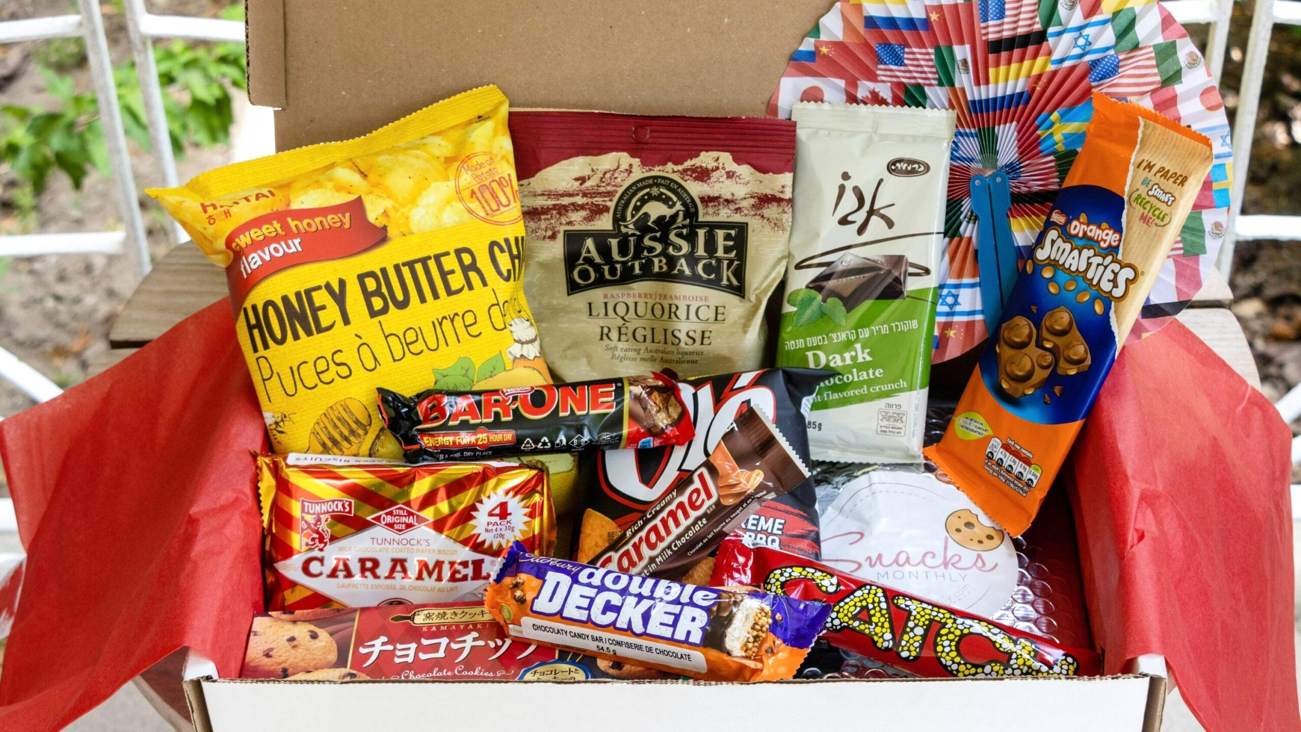 Box full of snacks from different countries.