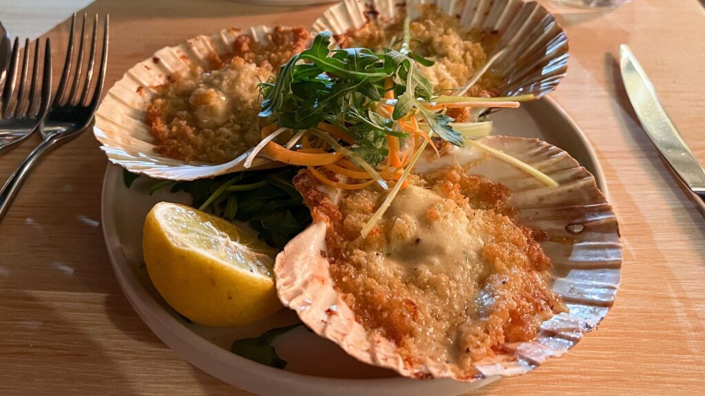 Three large scallops with parmesan.