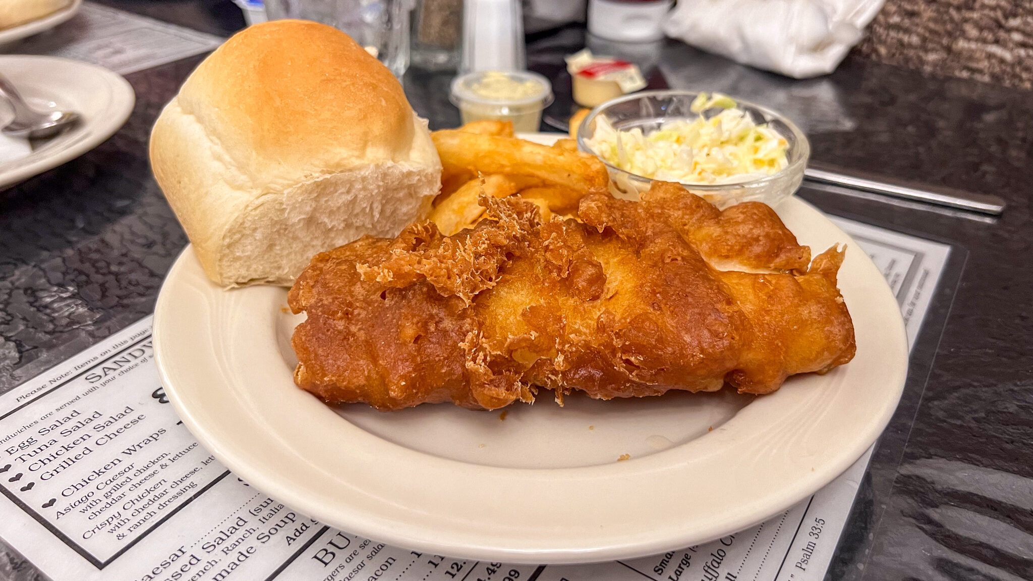 Breaded chicken with fries and coleslaw. 