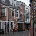 Historic lane in Glasgow with restaurants and bars.