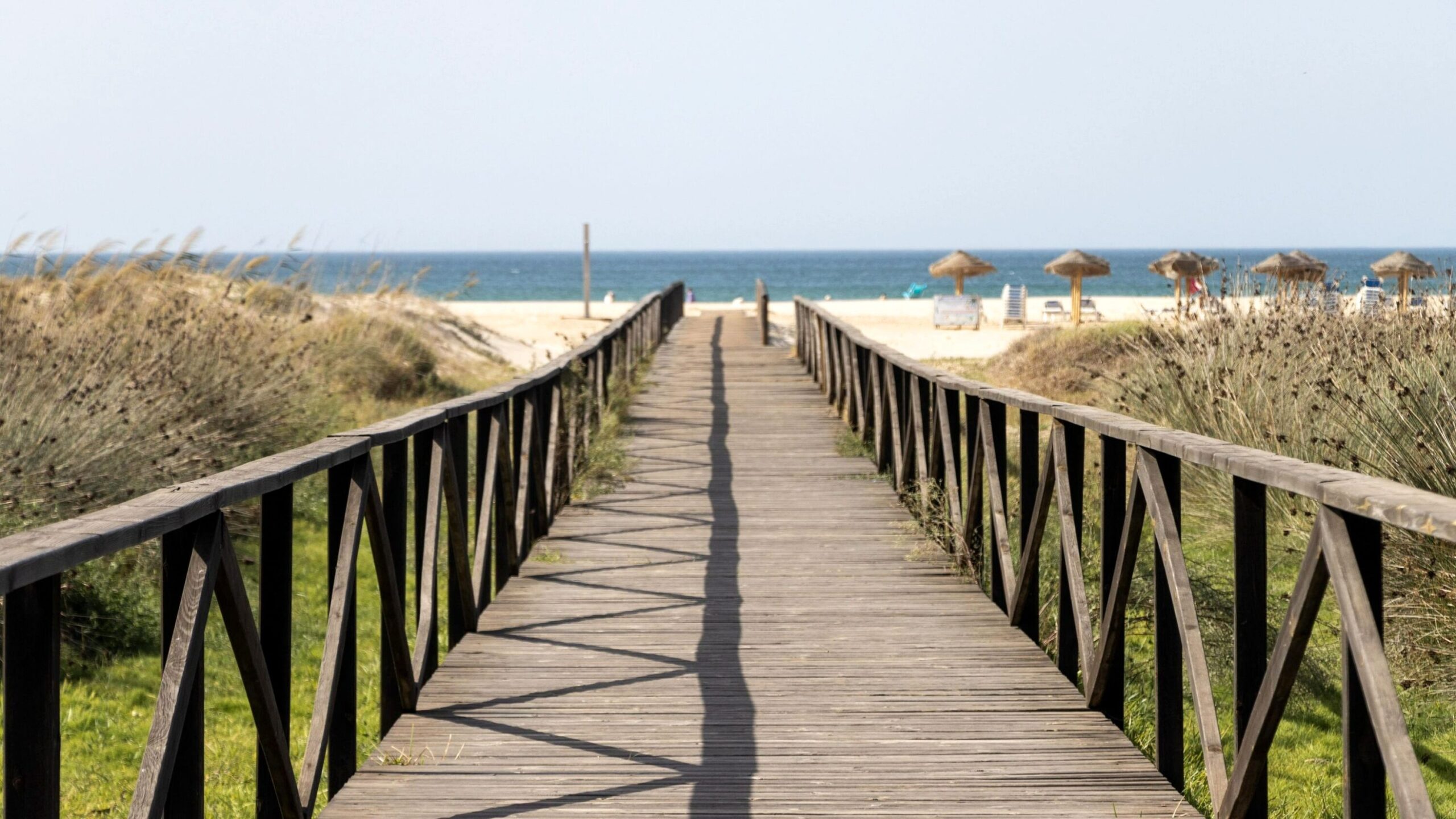 Wooden boardwalk leading to beach.