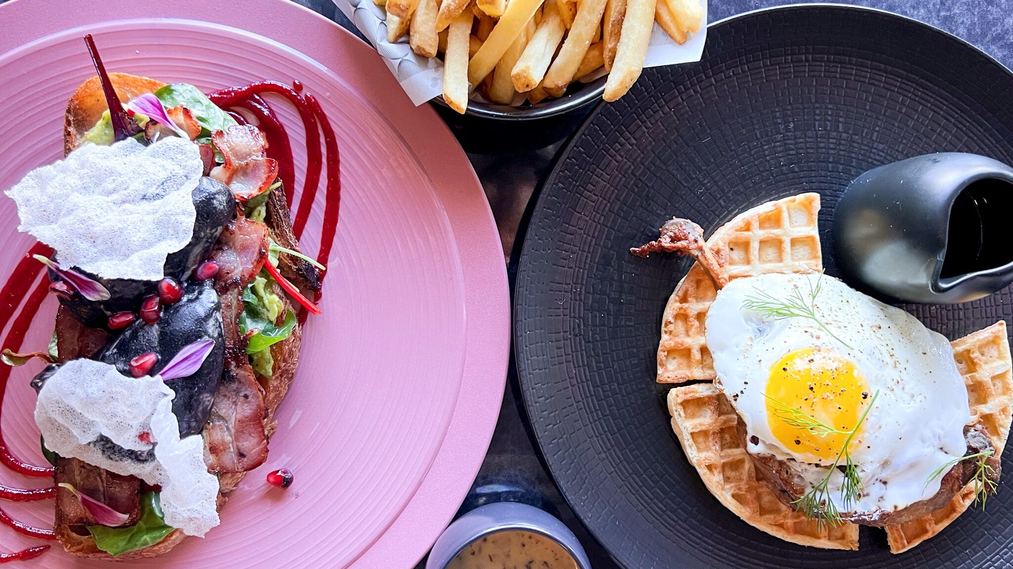 Two egg dishes with fries on the side.