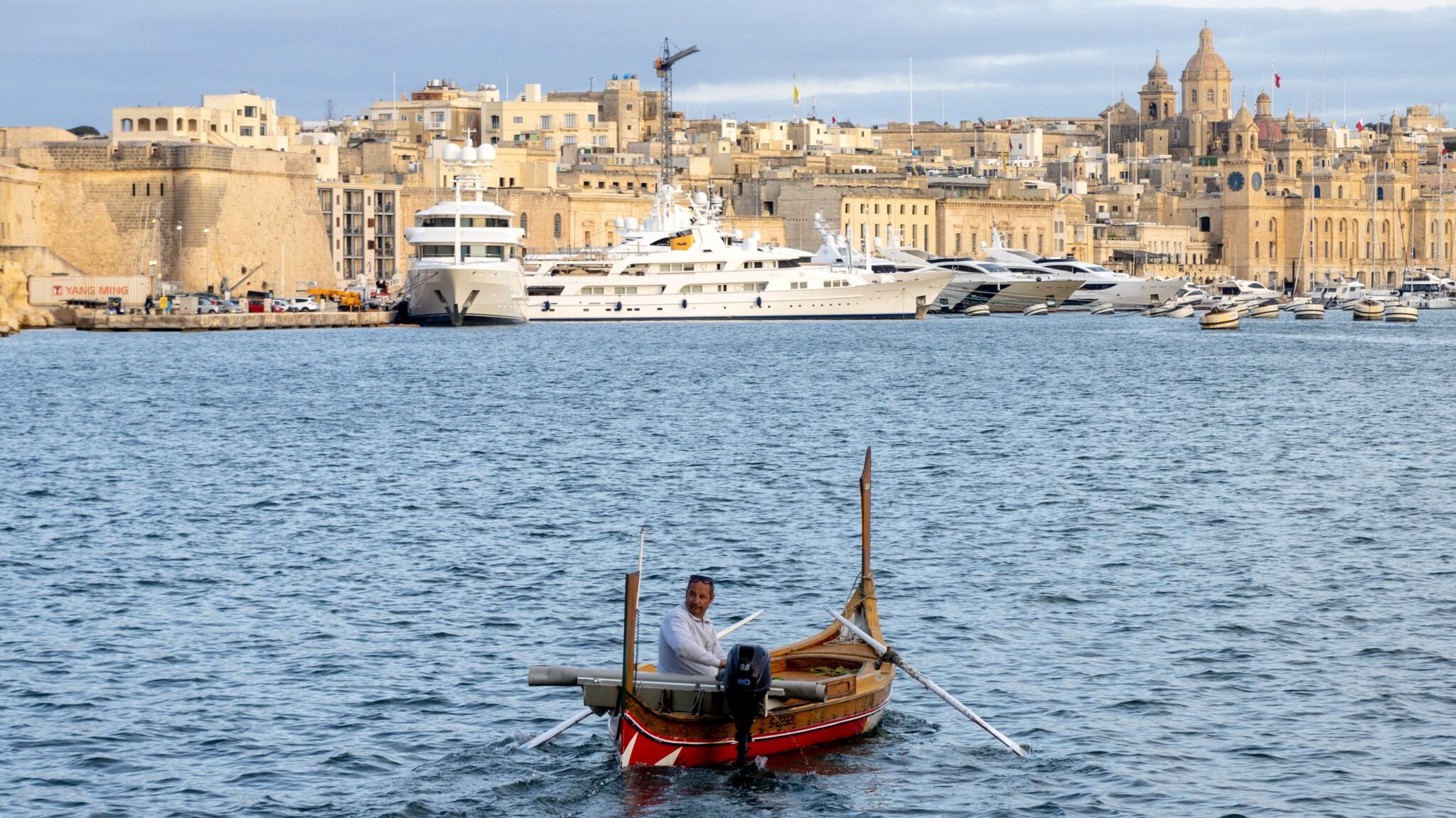 Traditional boat in Valletta at sunset.