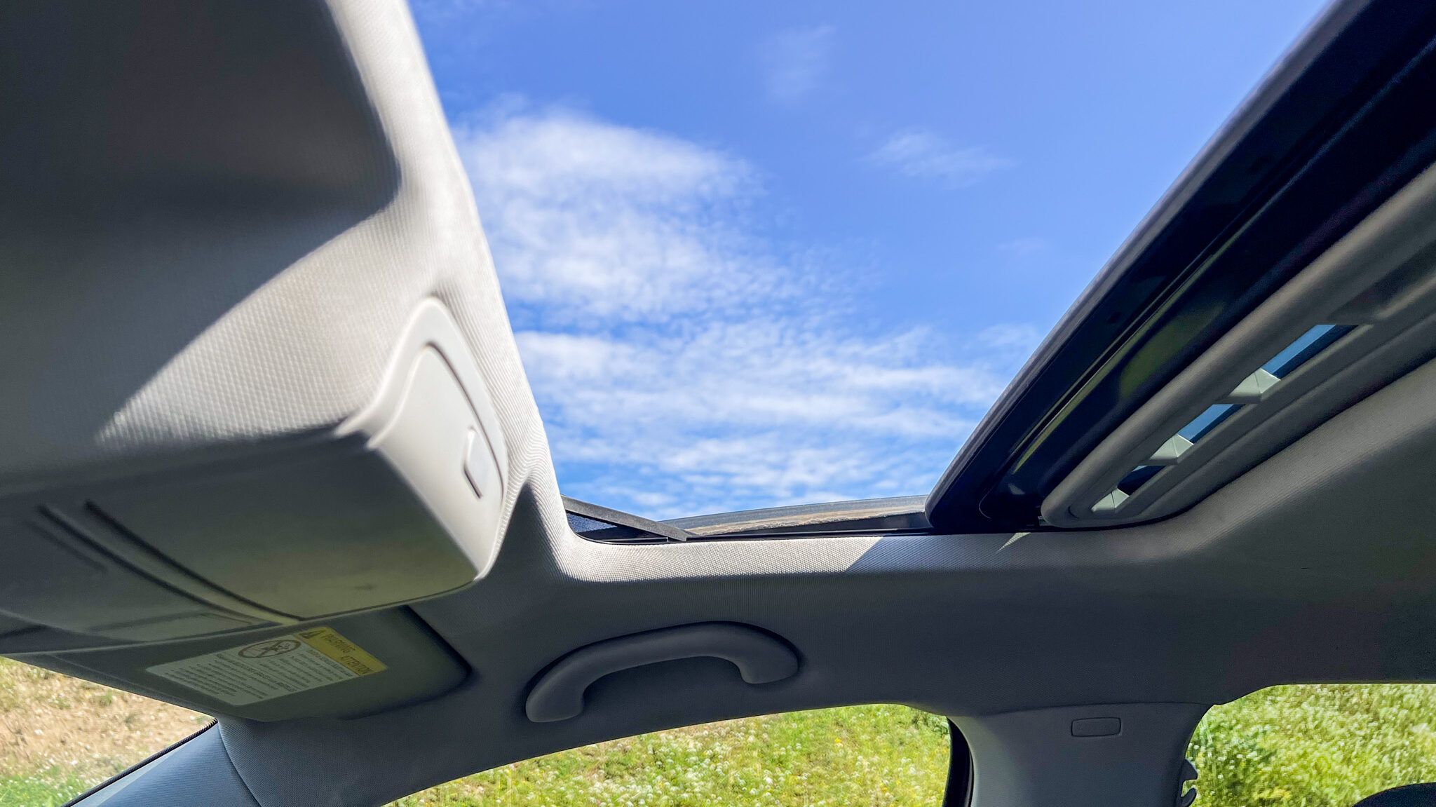 Sunroof open in rental car in Albania.