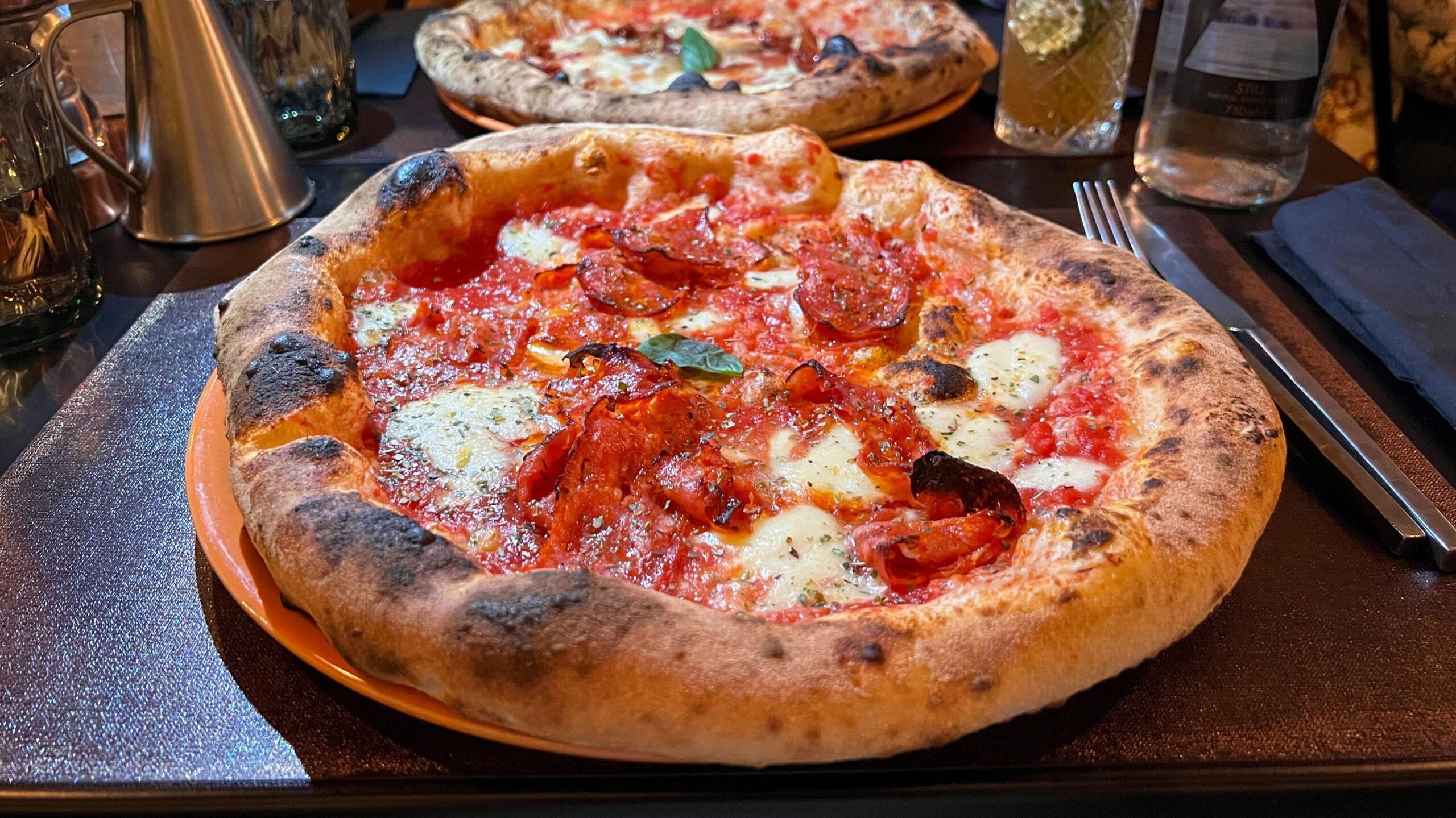 Two stone baked pizzas on table restaurants on Gozo.