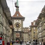 Medieval clock tower at the end of a street.