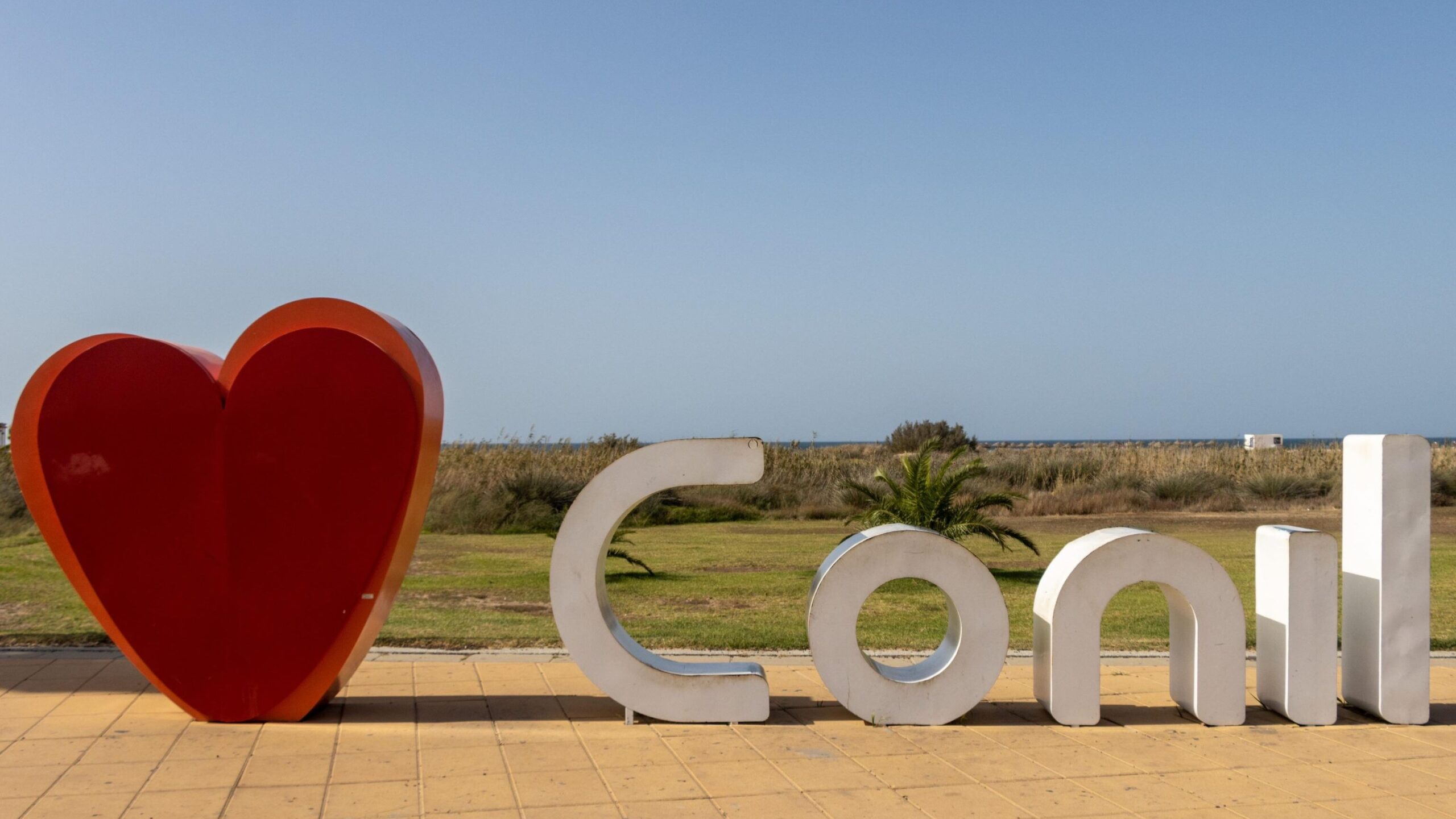 I heart Conil sign along beach boardwalk.