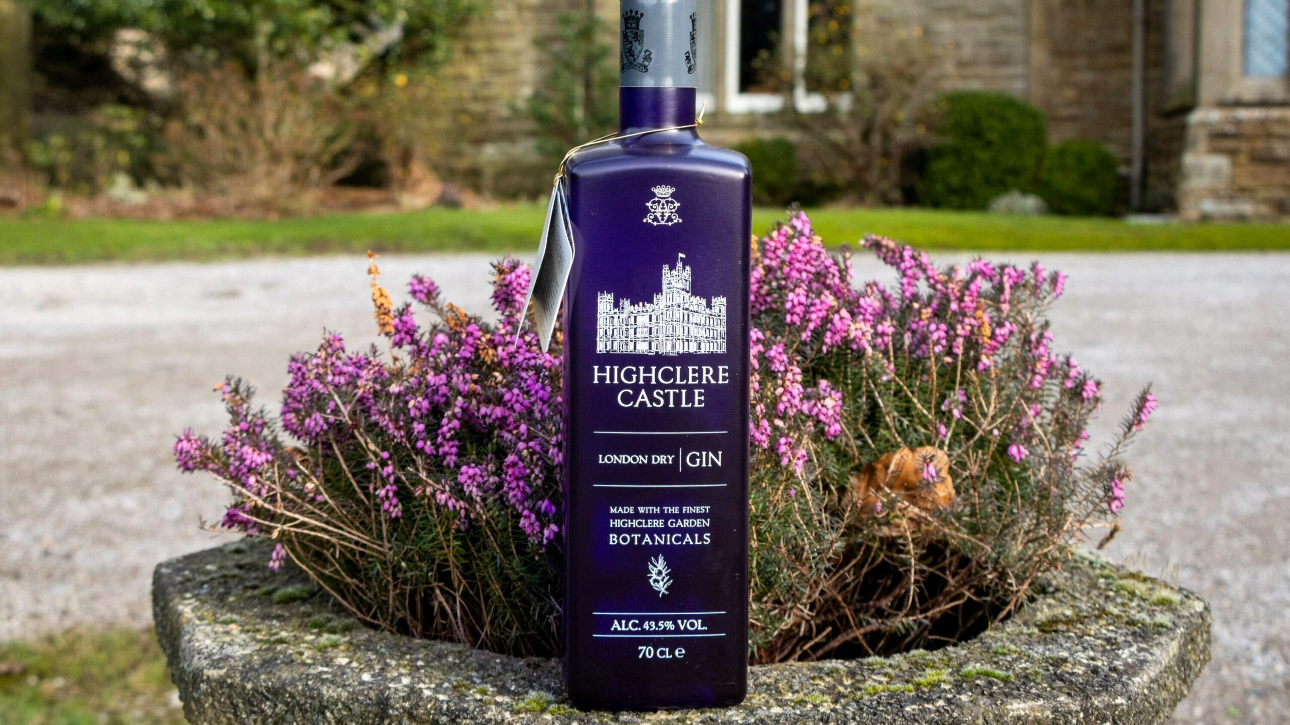 Purple bottle of gin outside castle.