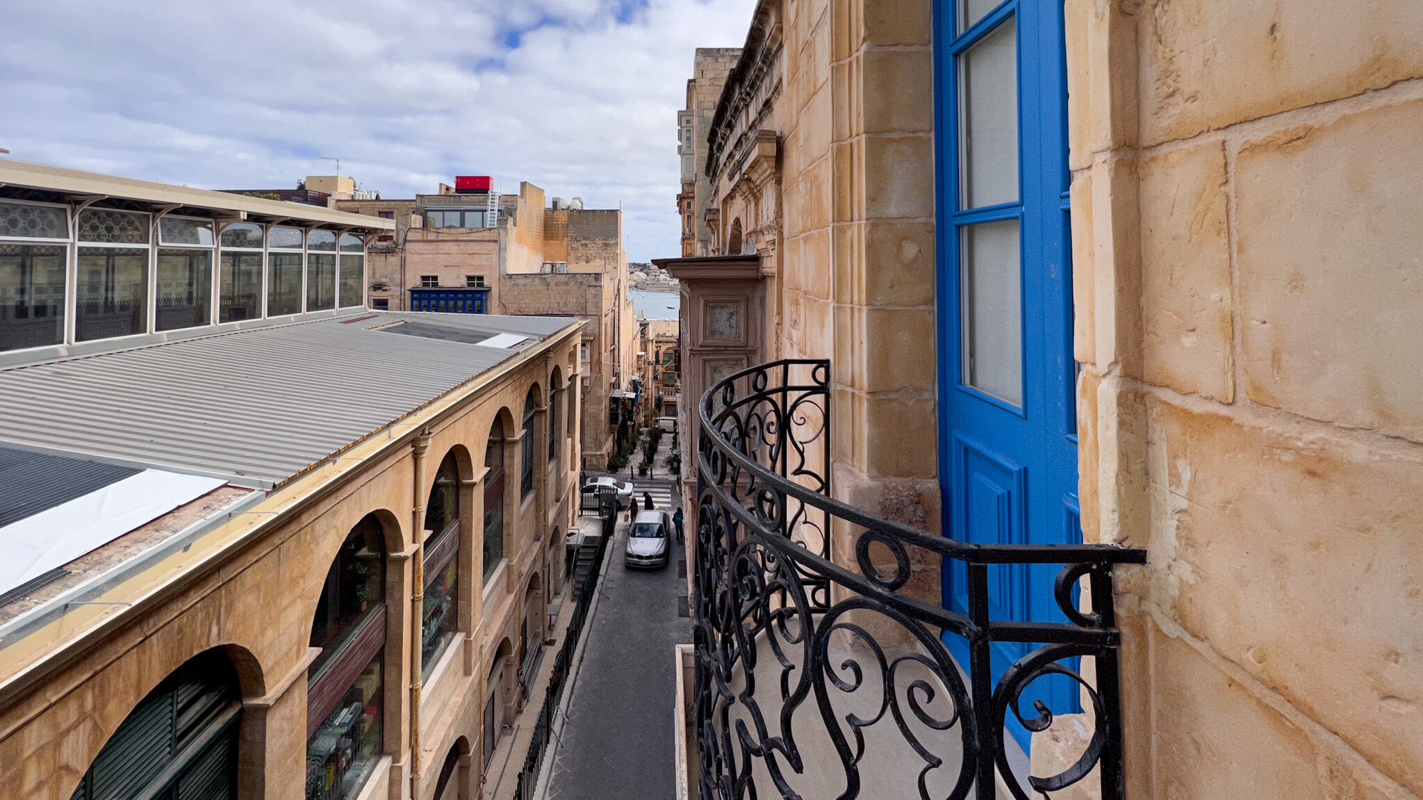 Maltese balcony at hotel with blue door.