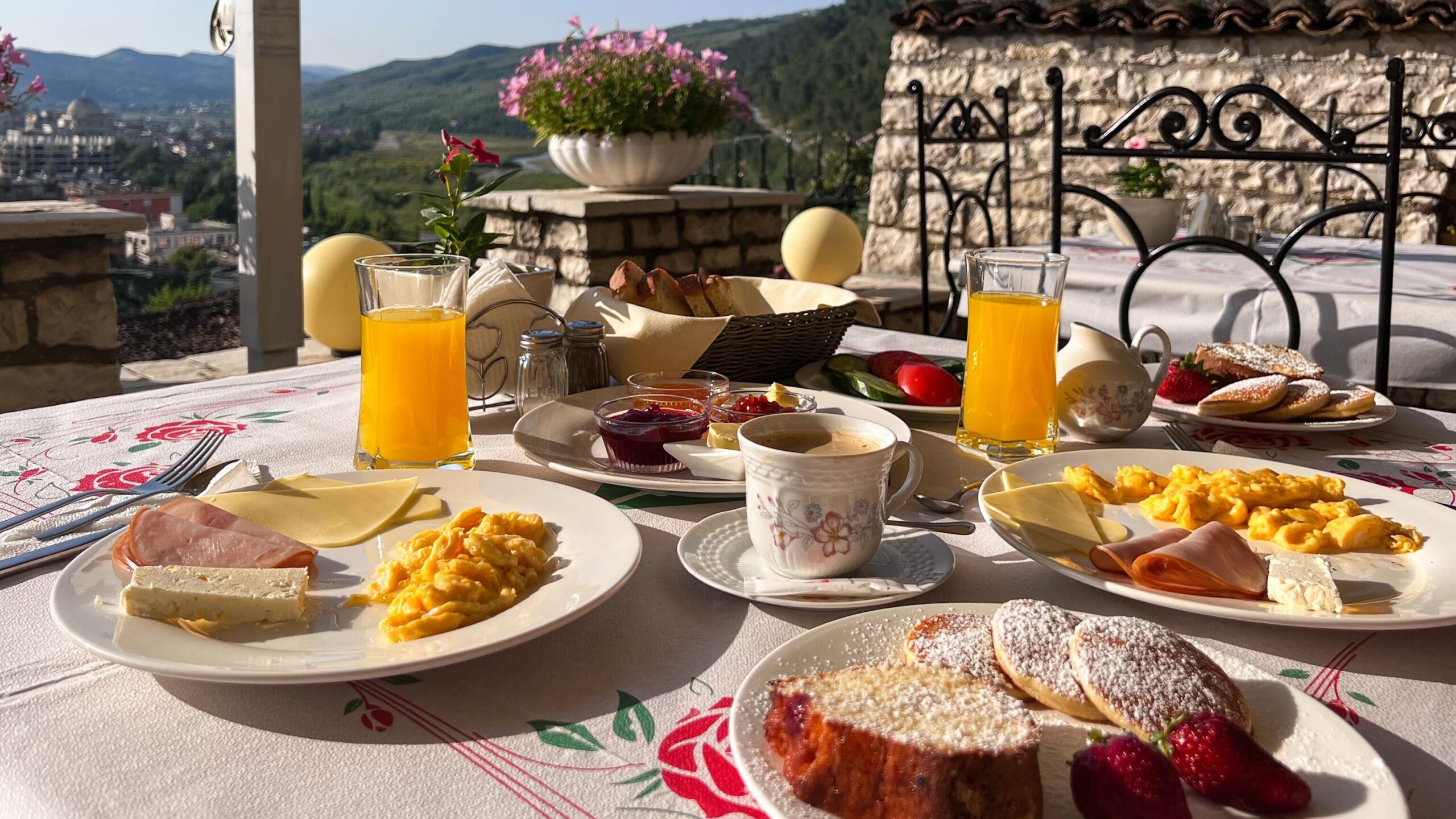 Breakfast set out on table on rooftop.