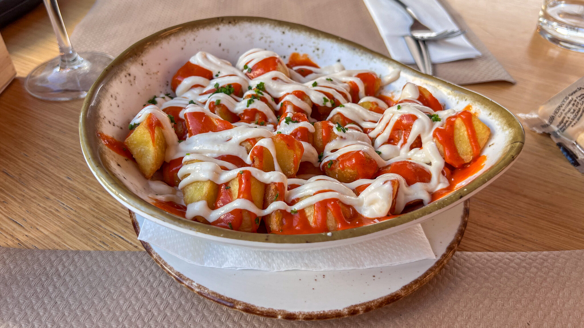 Bowl of patatas bravas in restaurant. 