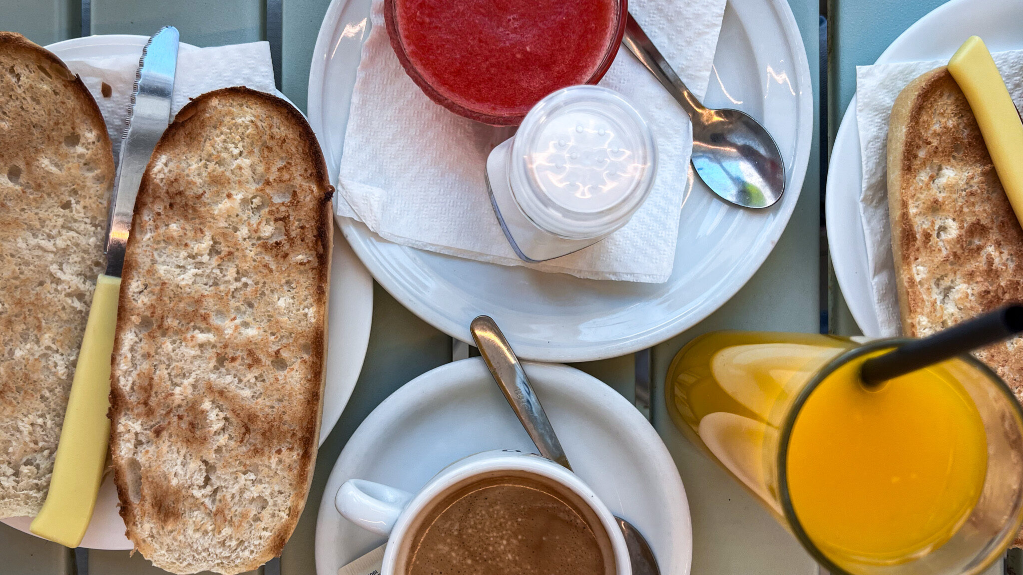 Sliced baguettes with tomato spread.