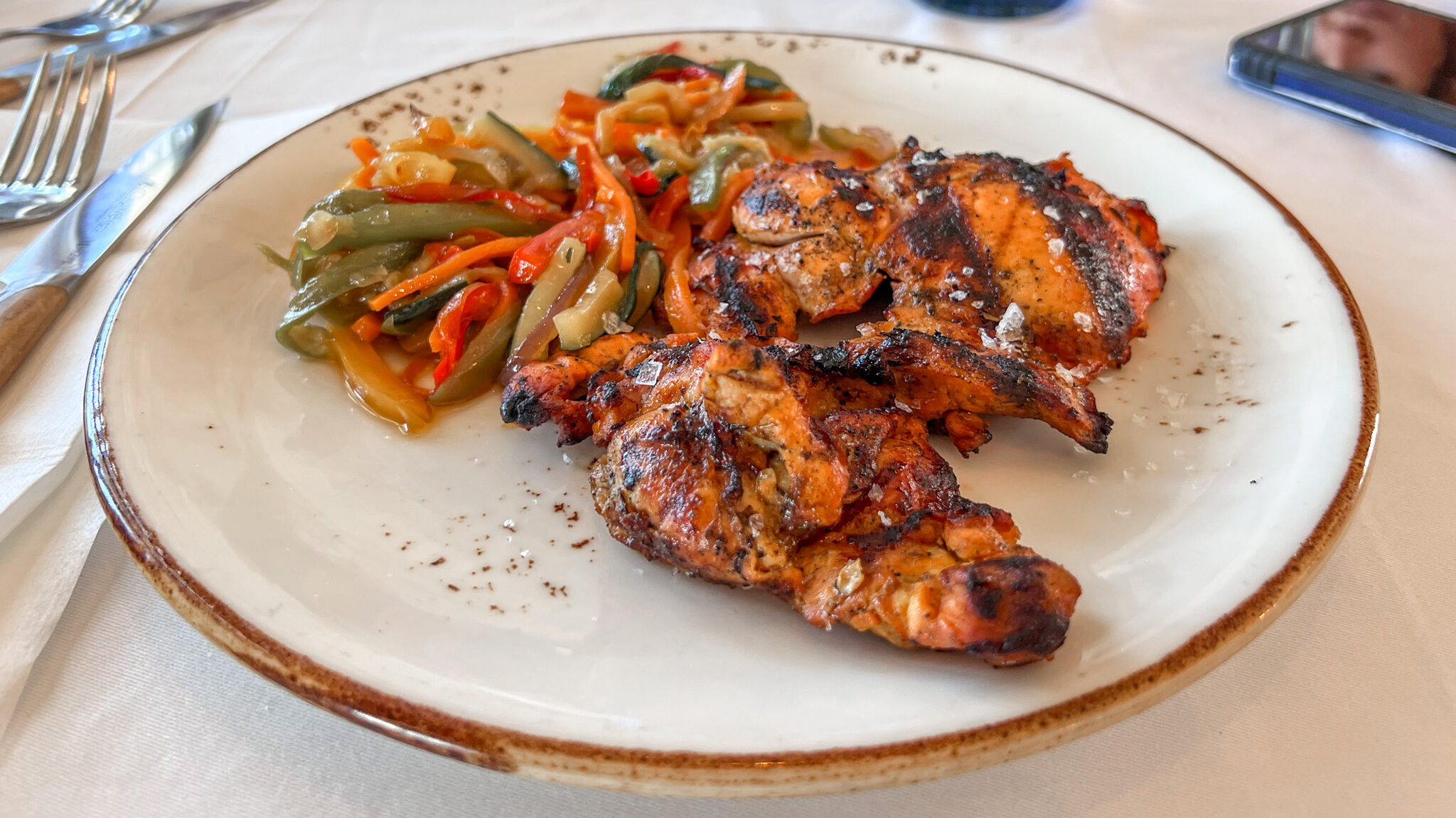 Plate of fried vegetables and grilled chicken.