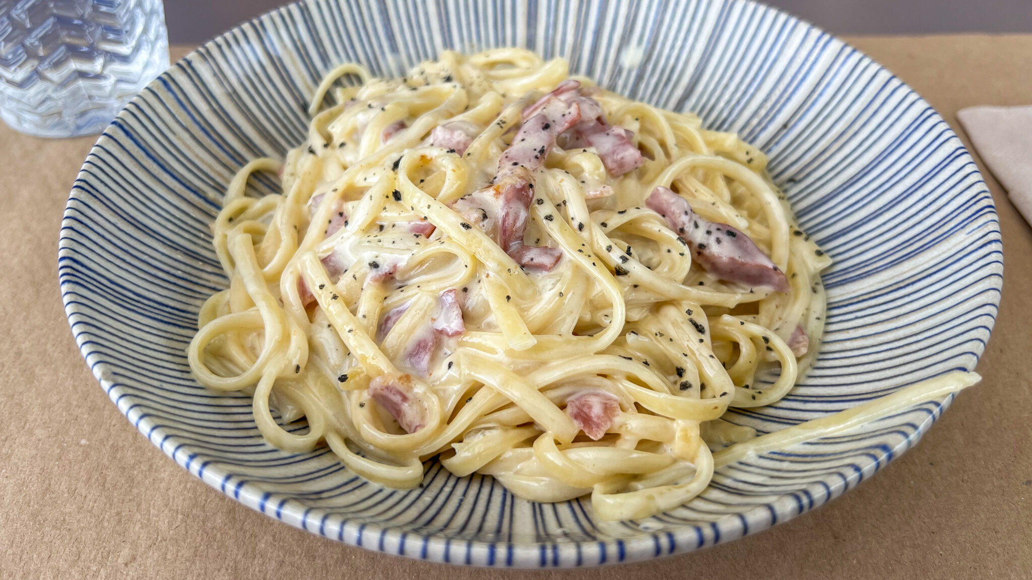 Bowl filled with creamy carbonara. 