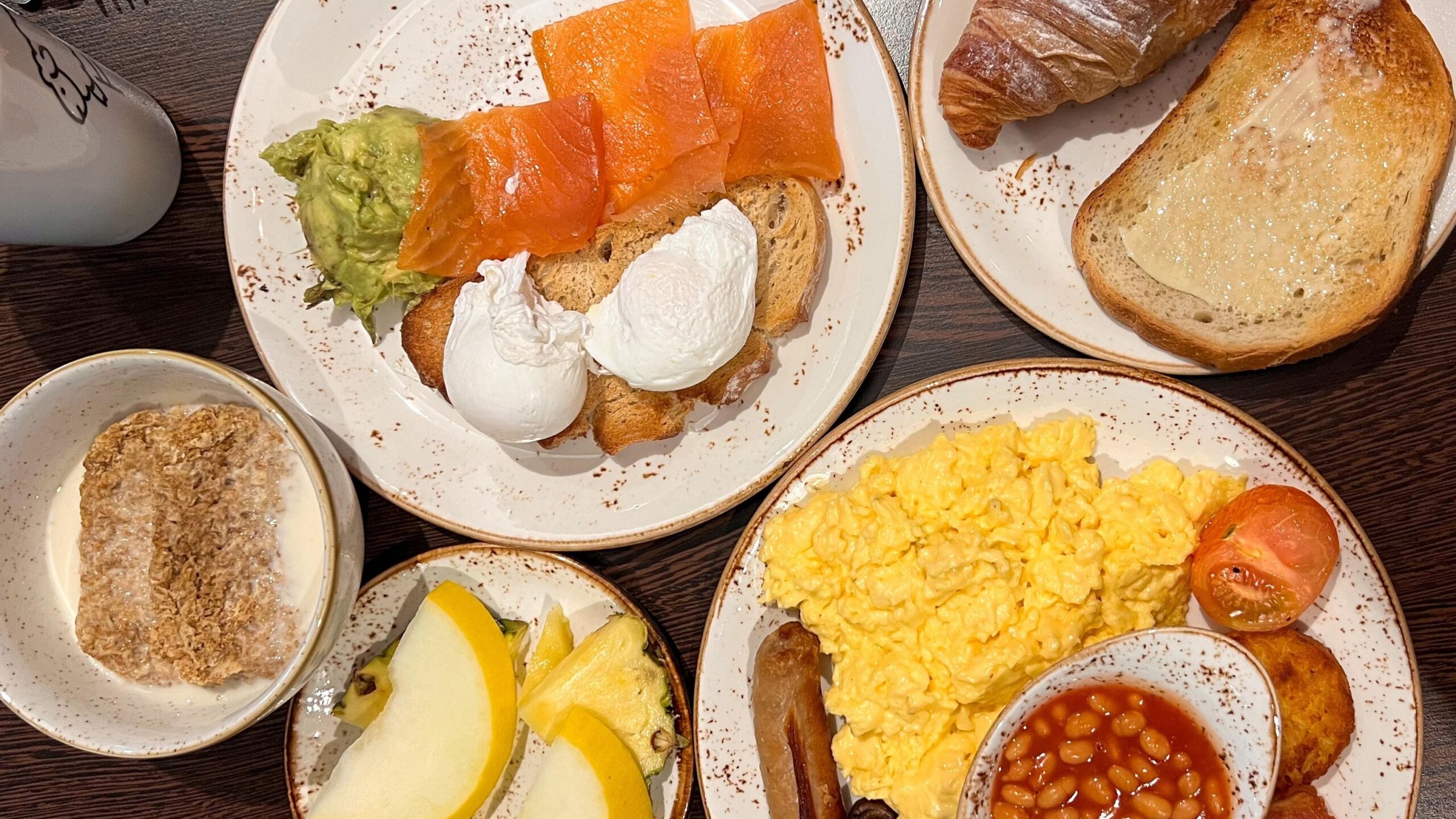 Selection of breakfast items on plates in hotel.