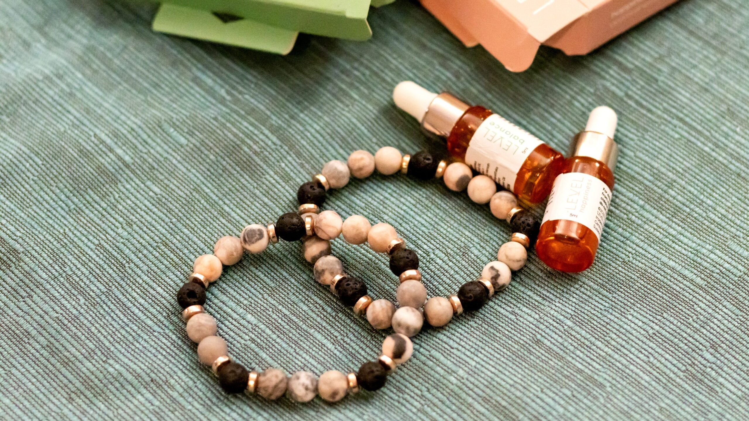 Two lava bead bracelets with essential oils.