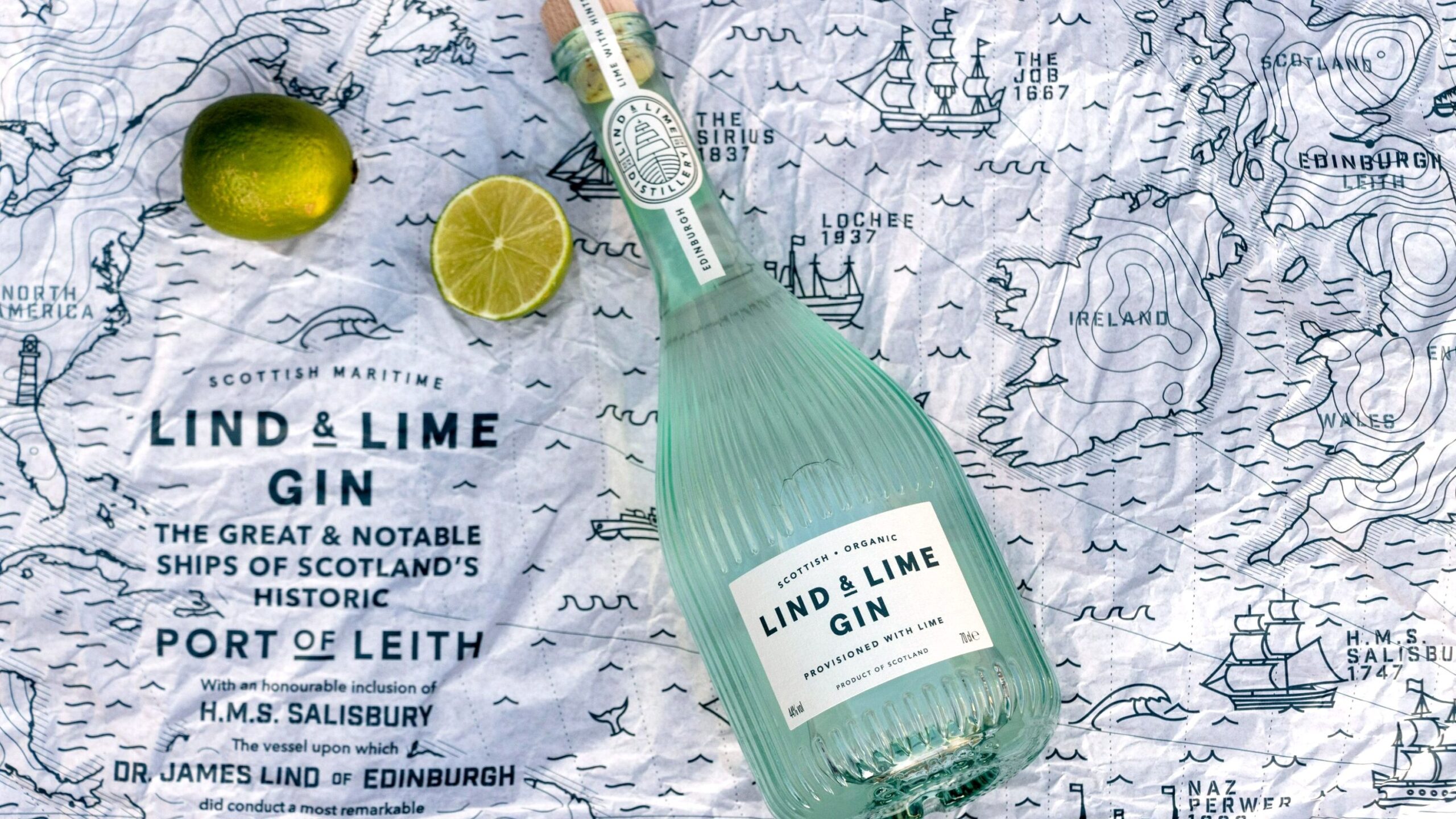 Fancy bottle of gin sitting on map.