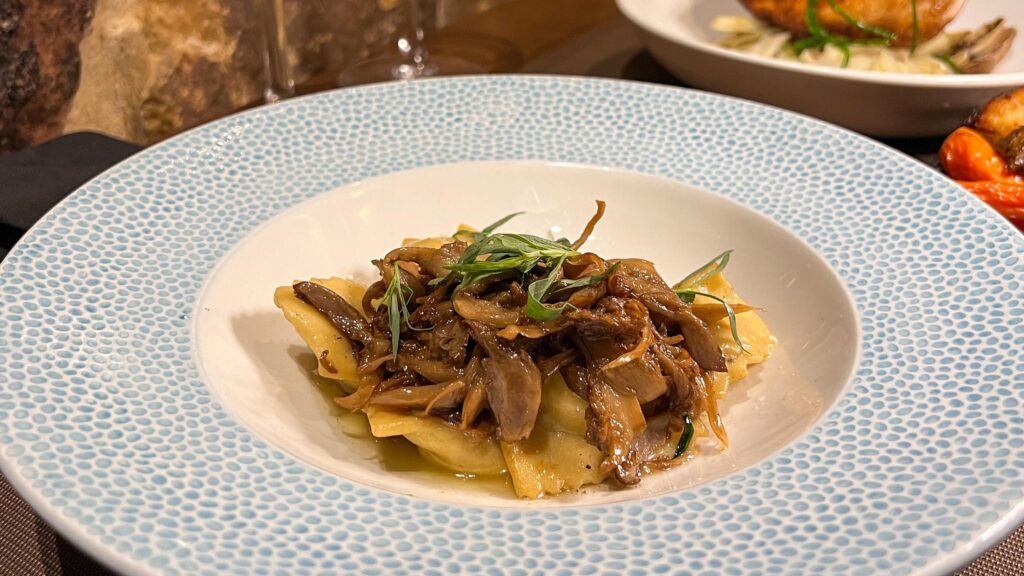 Black truffle pasta served with mushrooms.