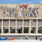 Museum building in Tirana with mural on the front.