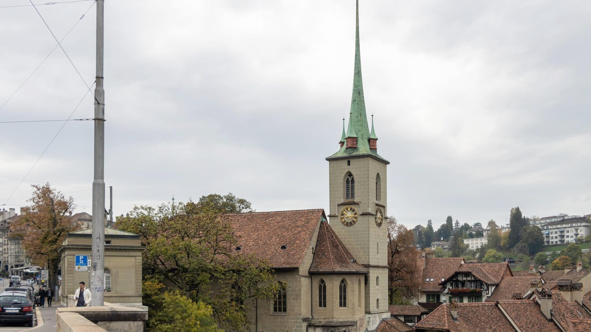 Spire of church sticking out above rooftops. 