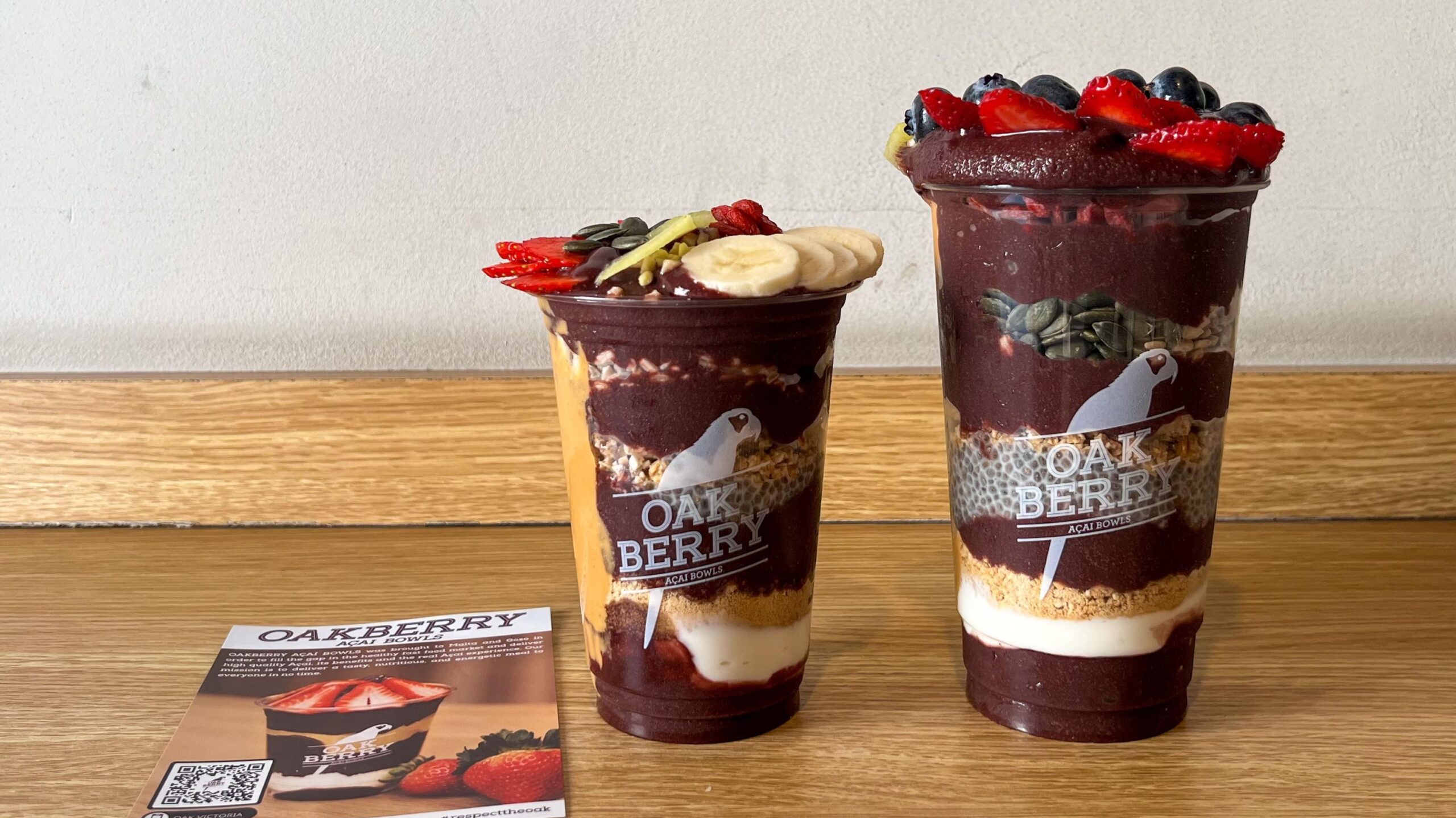 Two sizes of acai cups on table.