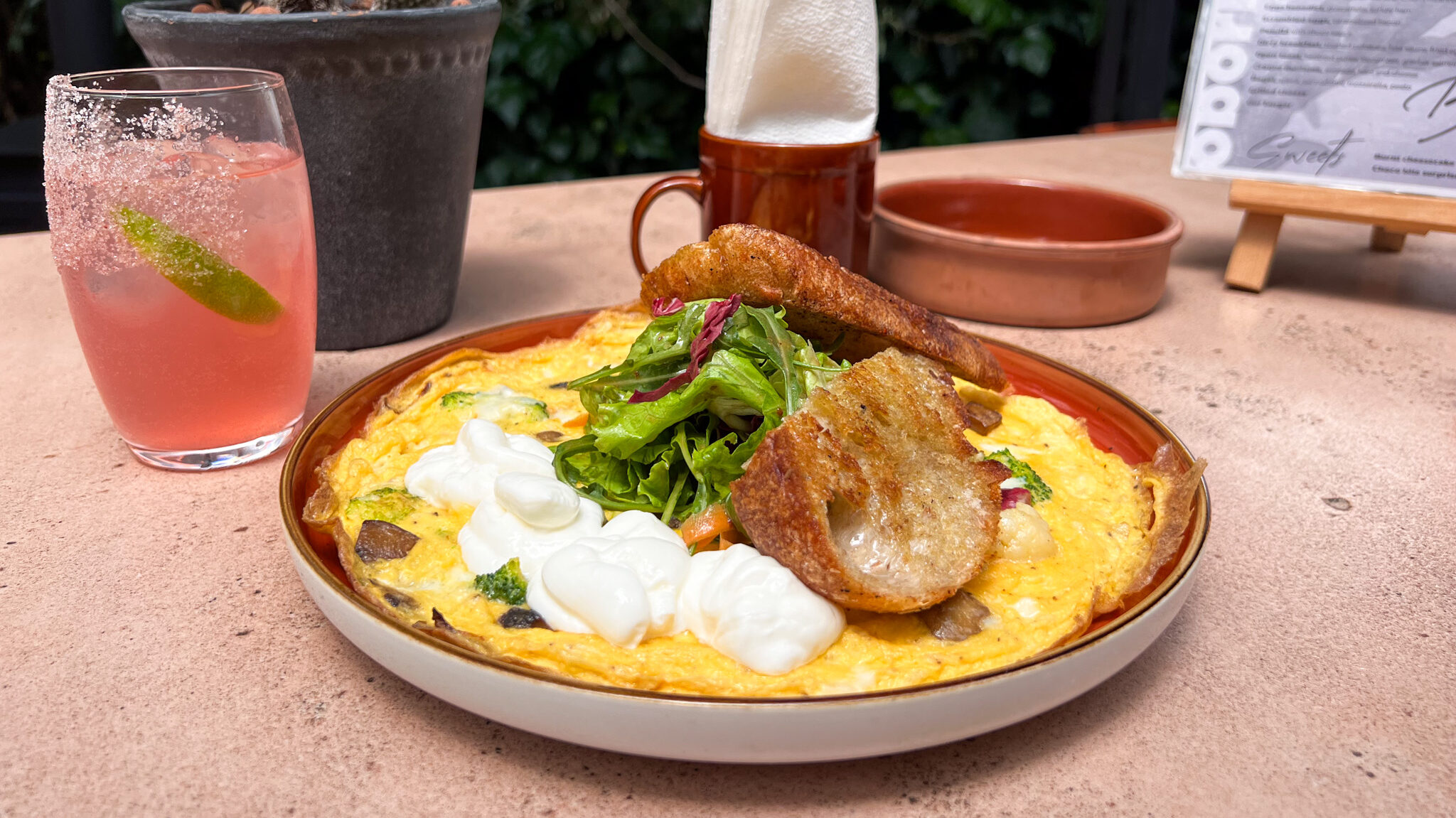 Open omelete with yogurt and toast.