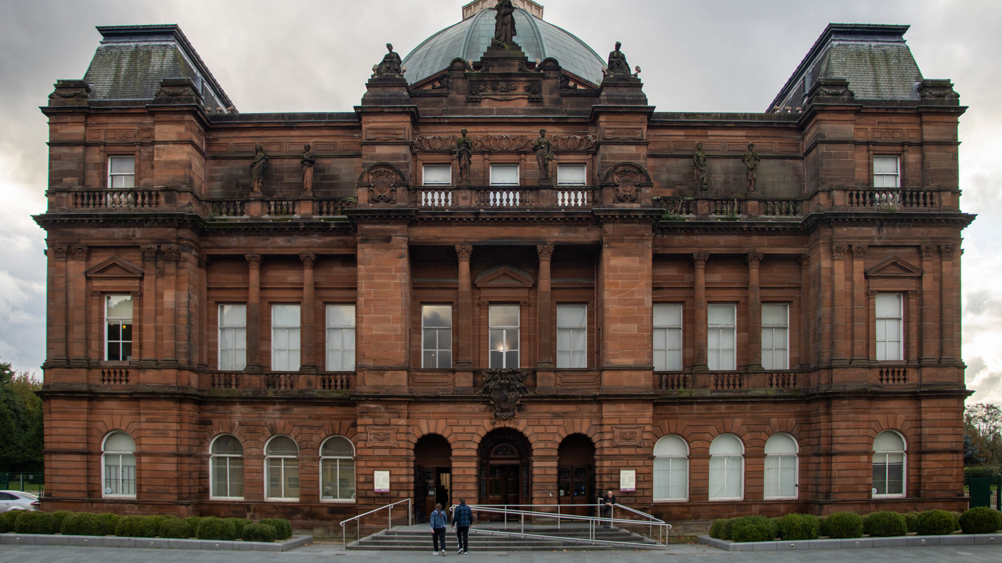 Exterior of orange brick palace in Glasgow.