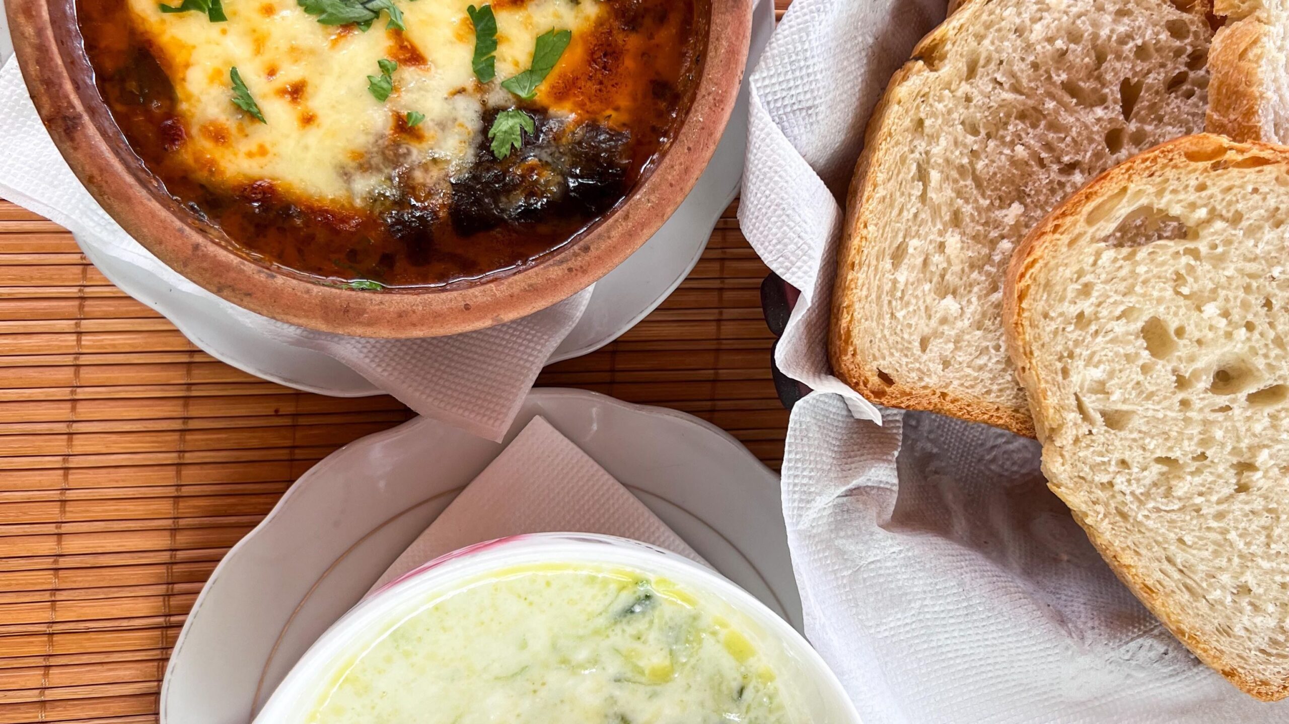 Cucumber soup with bread and lasagna. 