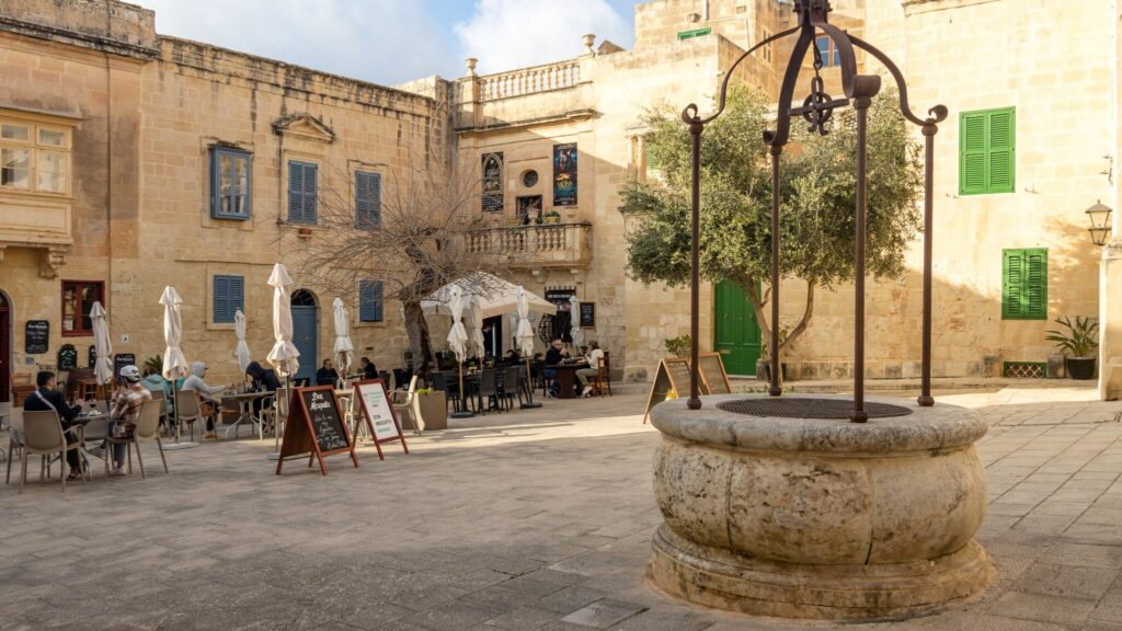 Historic square in Mdina with well.